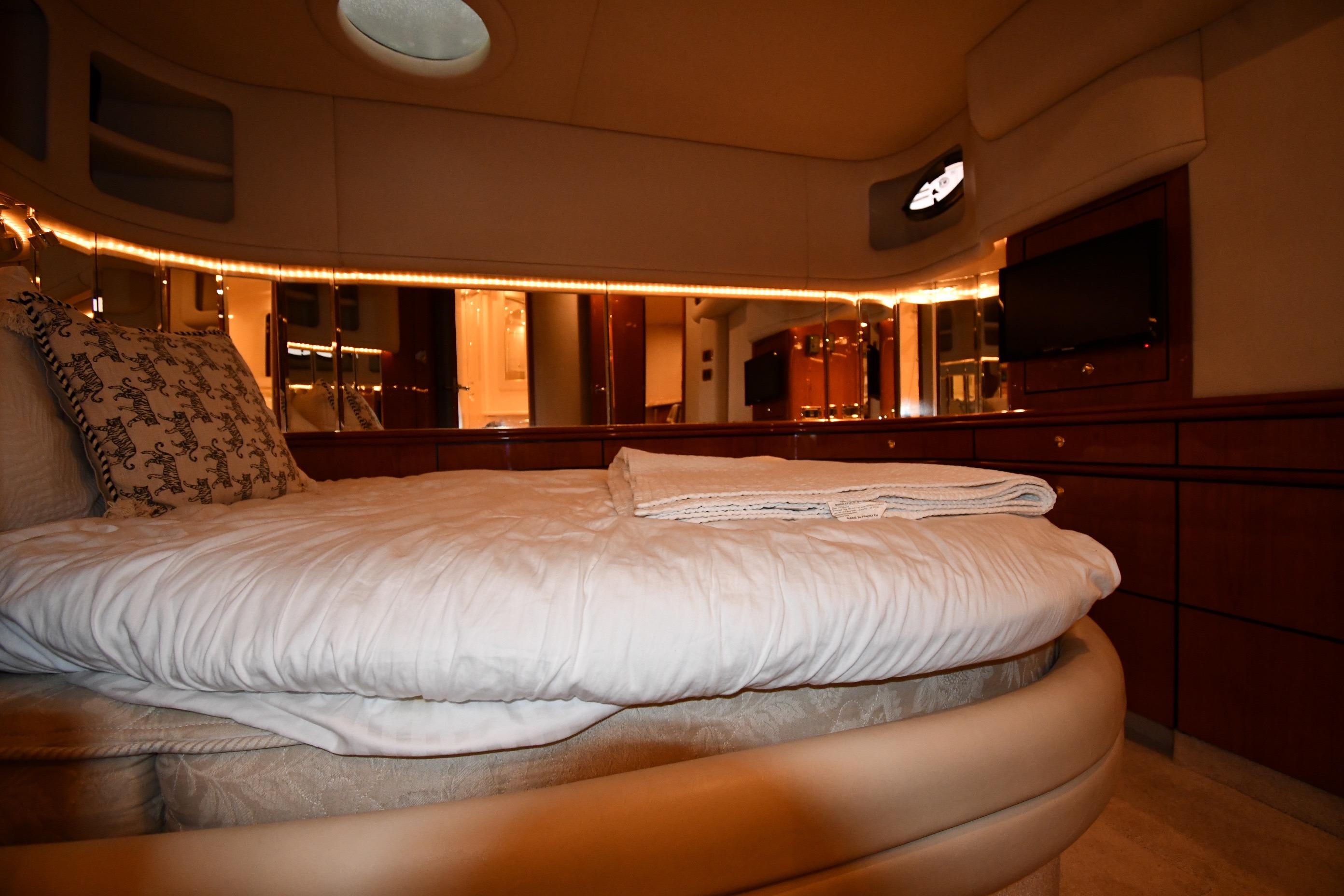 Luxurious bedroom interior of 2001 Sea Ray 540 Sundancer yacht with elegant bedding.