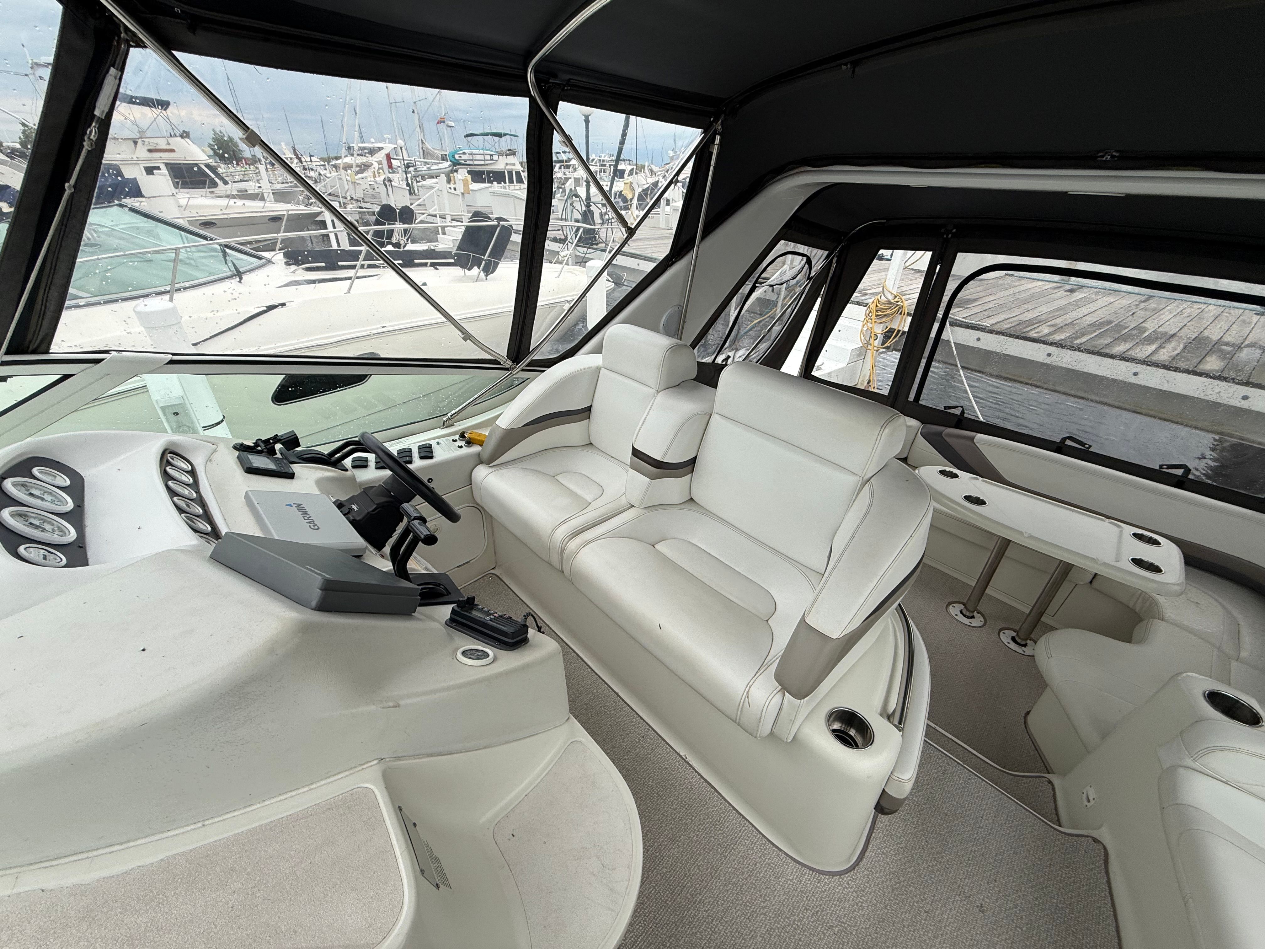 Interior of a 1995 Silverton 360 with white leather seating and helm station.