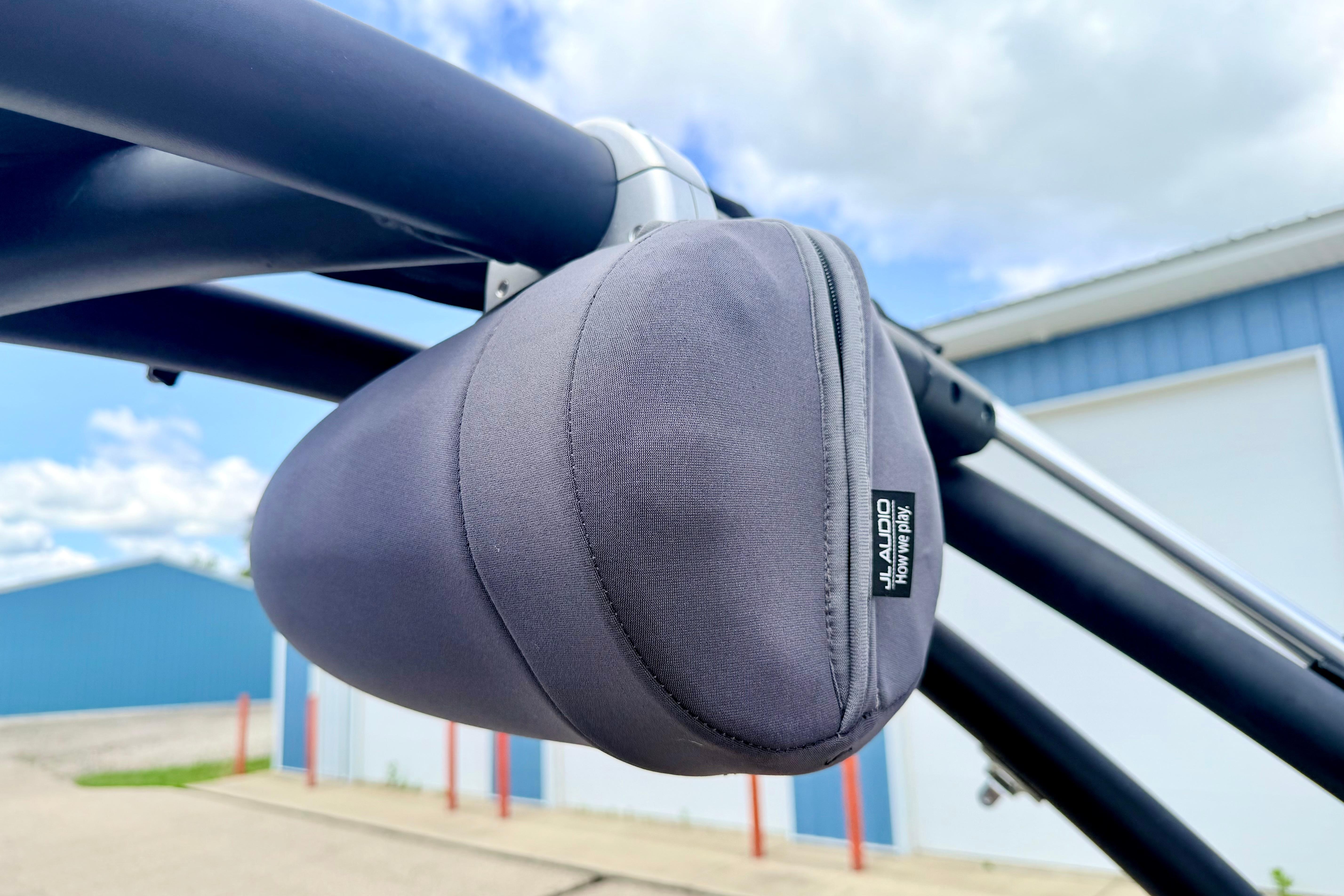 Protective cover on a 2018 Glastron GT 185 boat's audio speaker, with blue sky background.