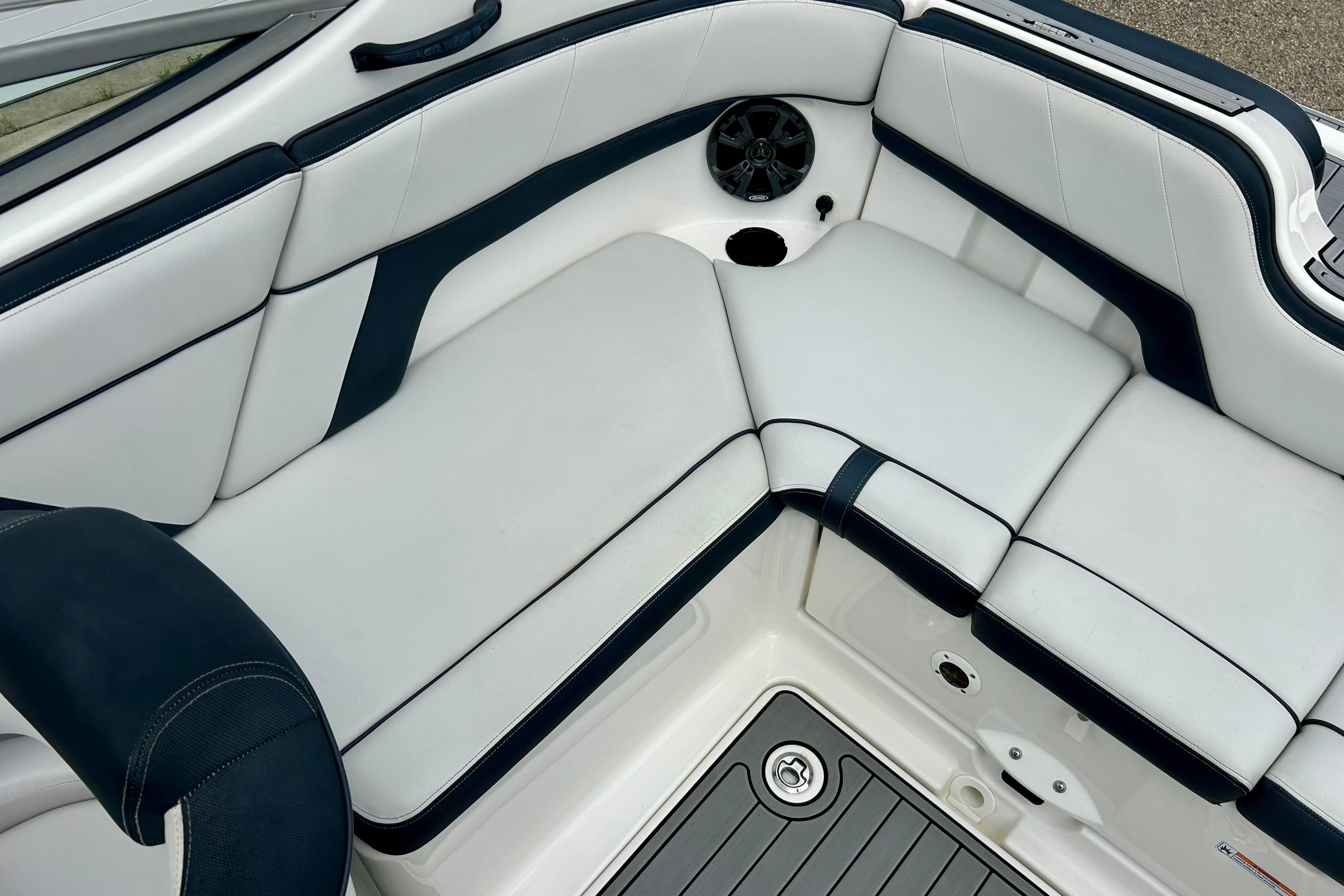 2015 Yamaha Boats AR210 interior seating with white and navy upholstery.
