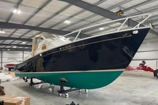 1964 Striker Model 120 boat in a spacious indoor storage facility.