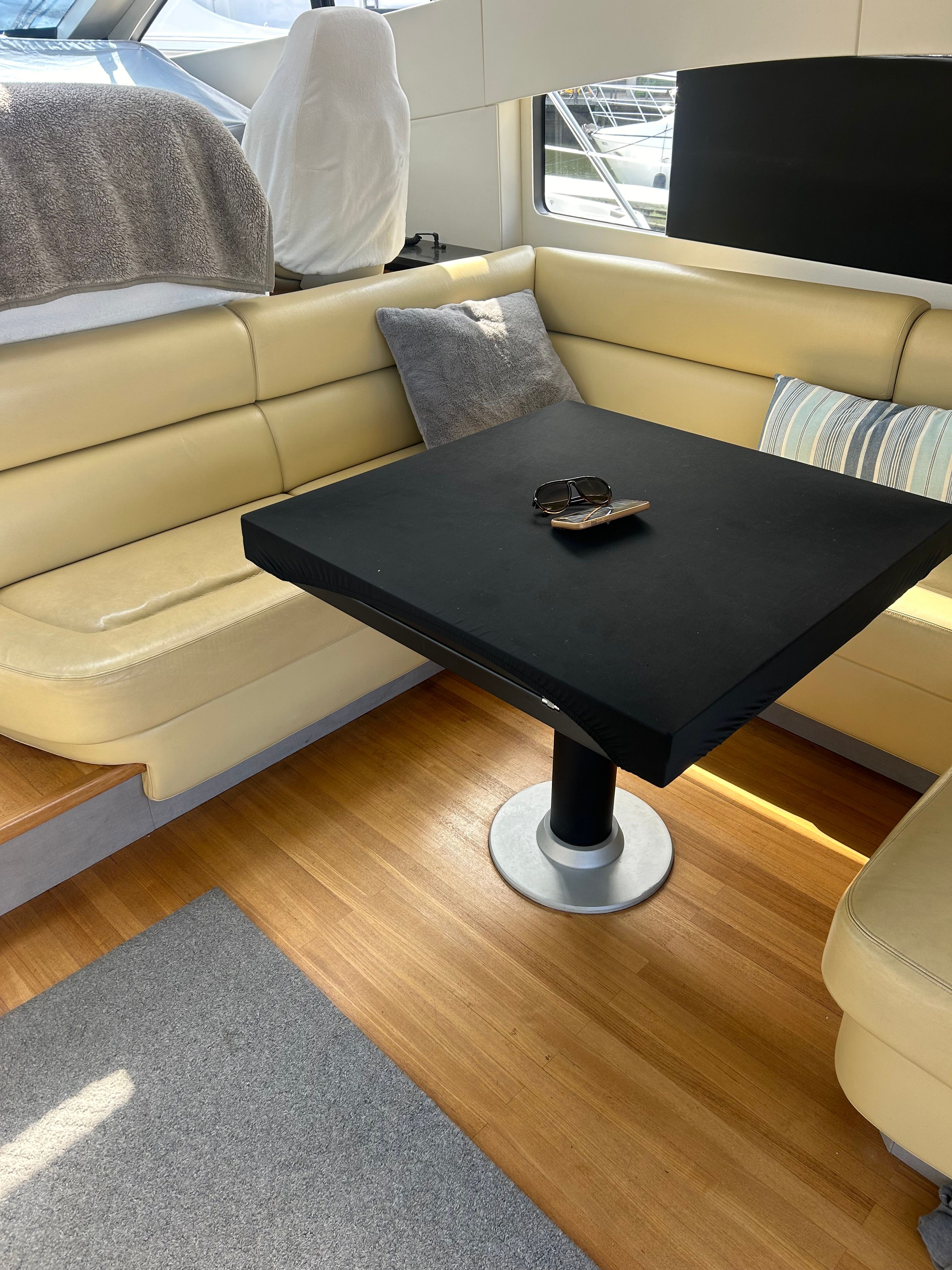 Interior of 2008 Sunseeker Predator 62 yacht with beige sofa and table.