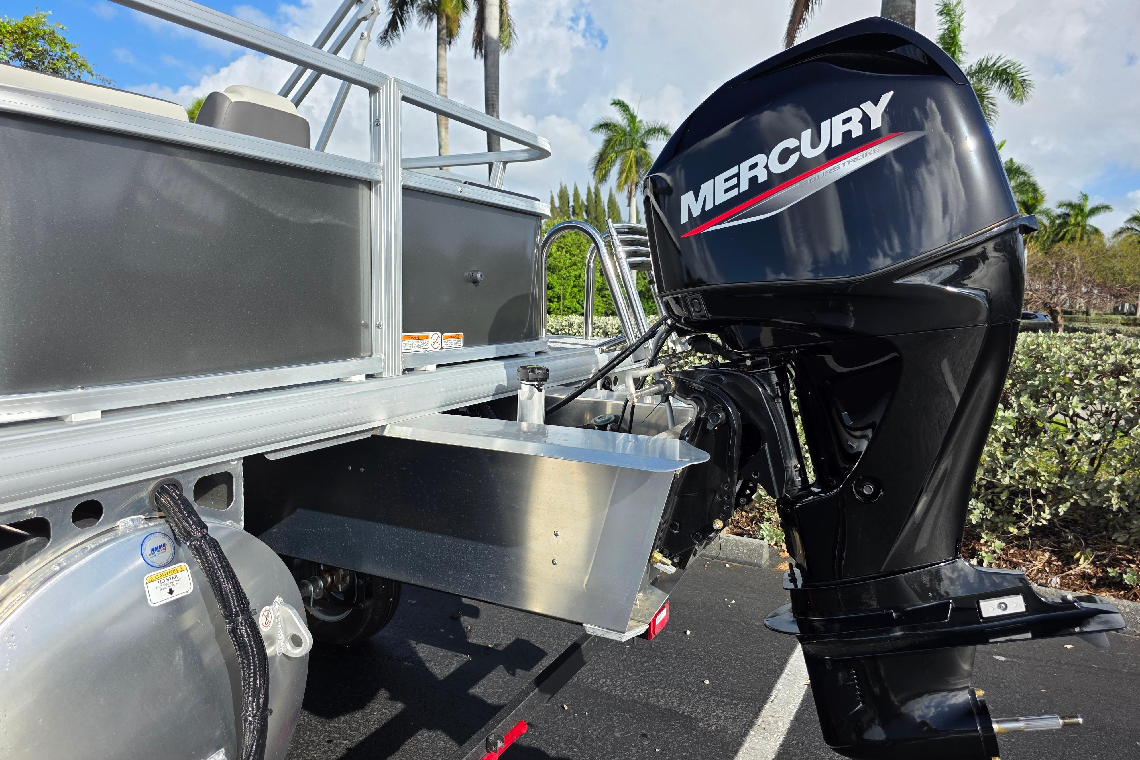 2026 Sun Tracker Bass Buggy 16 XL Select with Mercury outboard motor in a sunny setting.