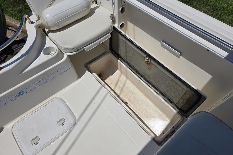 2004 Aquasport 215 Osprey Sport boat interior with open storage compartment.