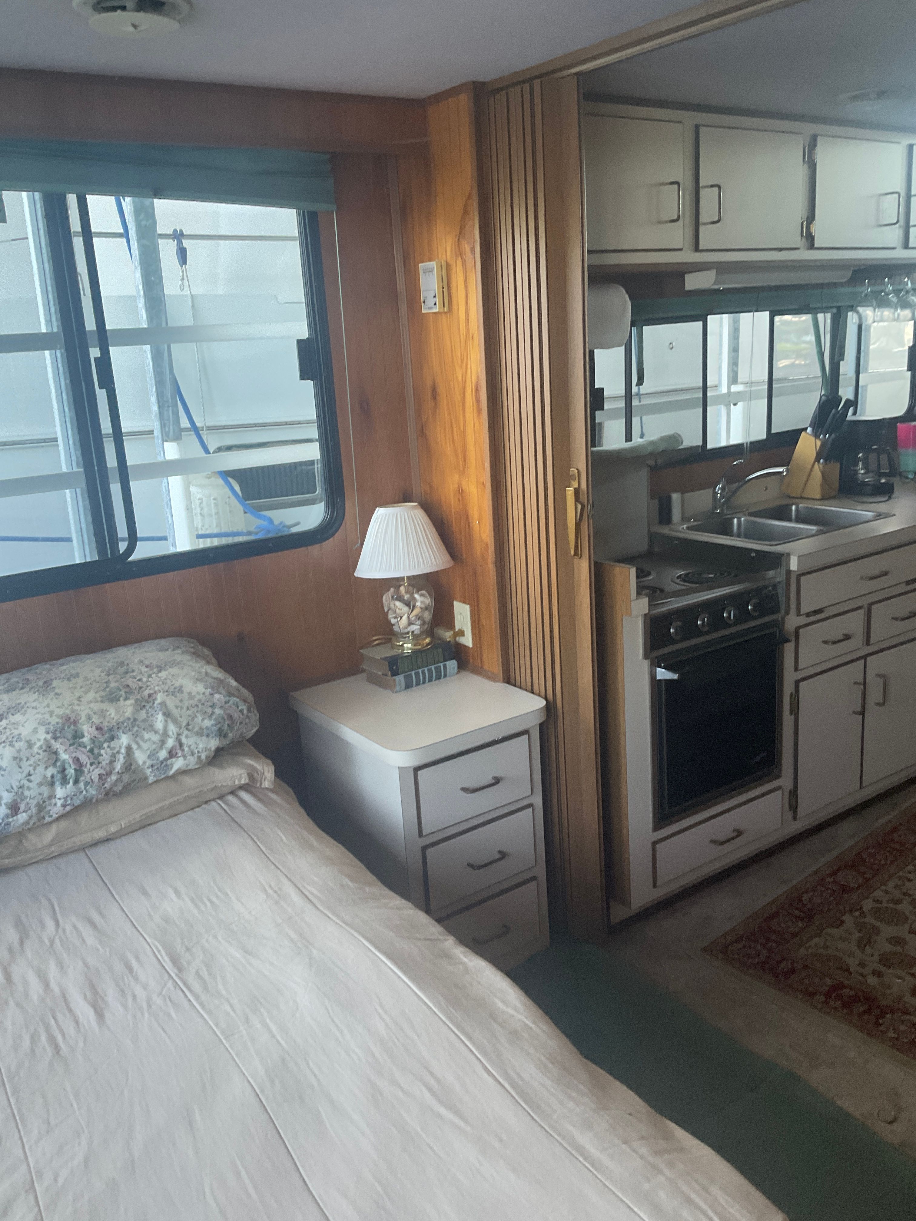 Interior of a 1996 Gibson 44 Standard with a bed and kitchen area.