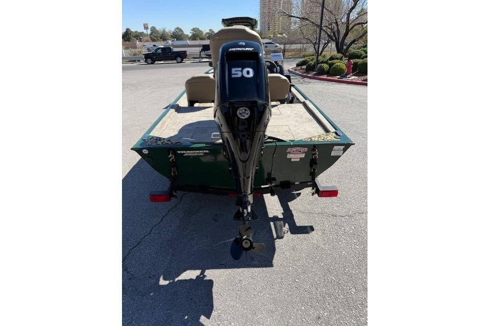 2026 Tracker Bass Tracker Classic Limited boat with Mercury 50 engine, parked outdoors.