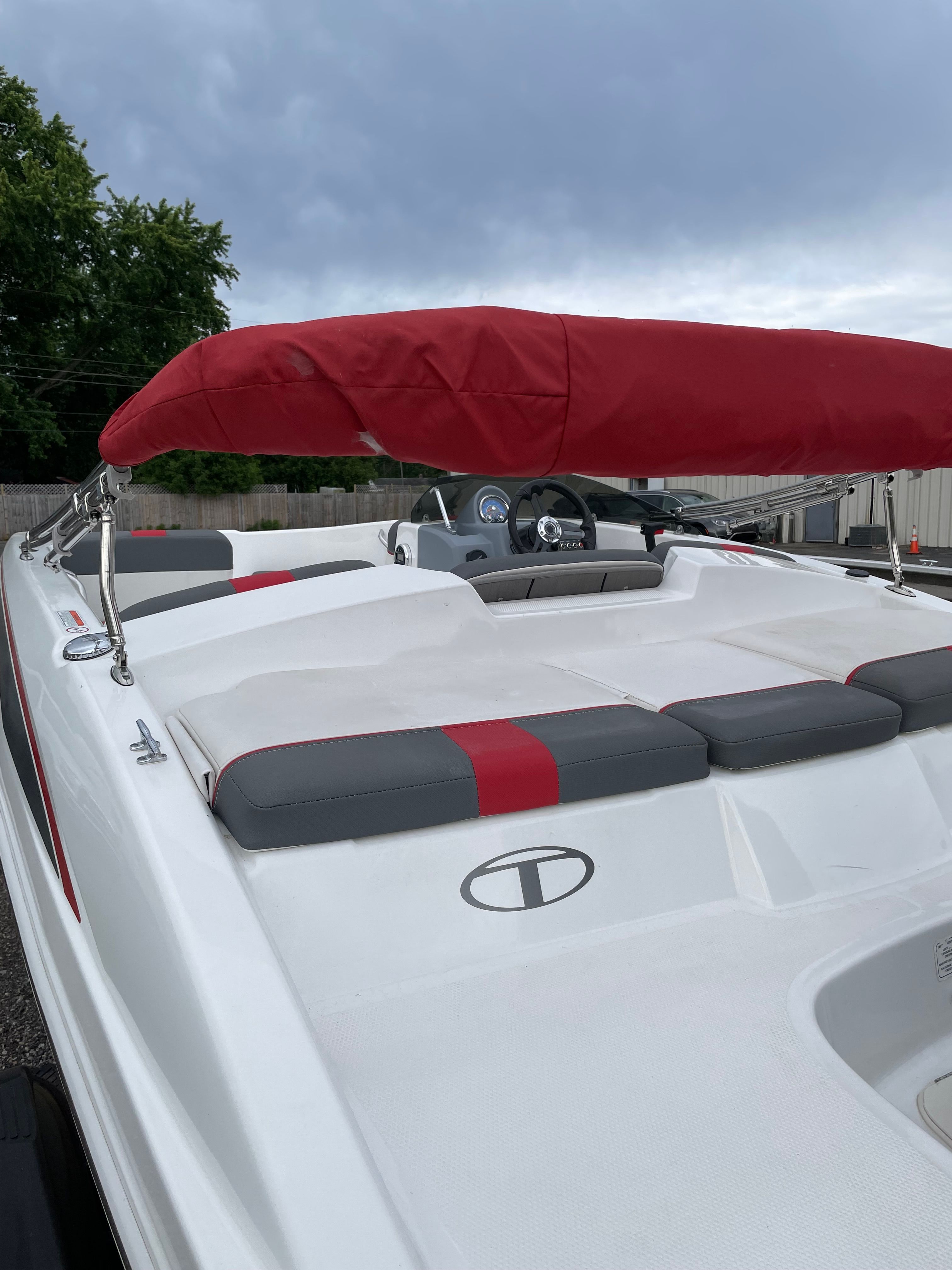 2022 Tahoe T16 boat with red sunshade and gray seats.