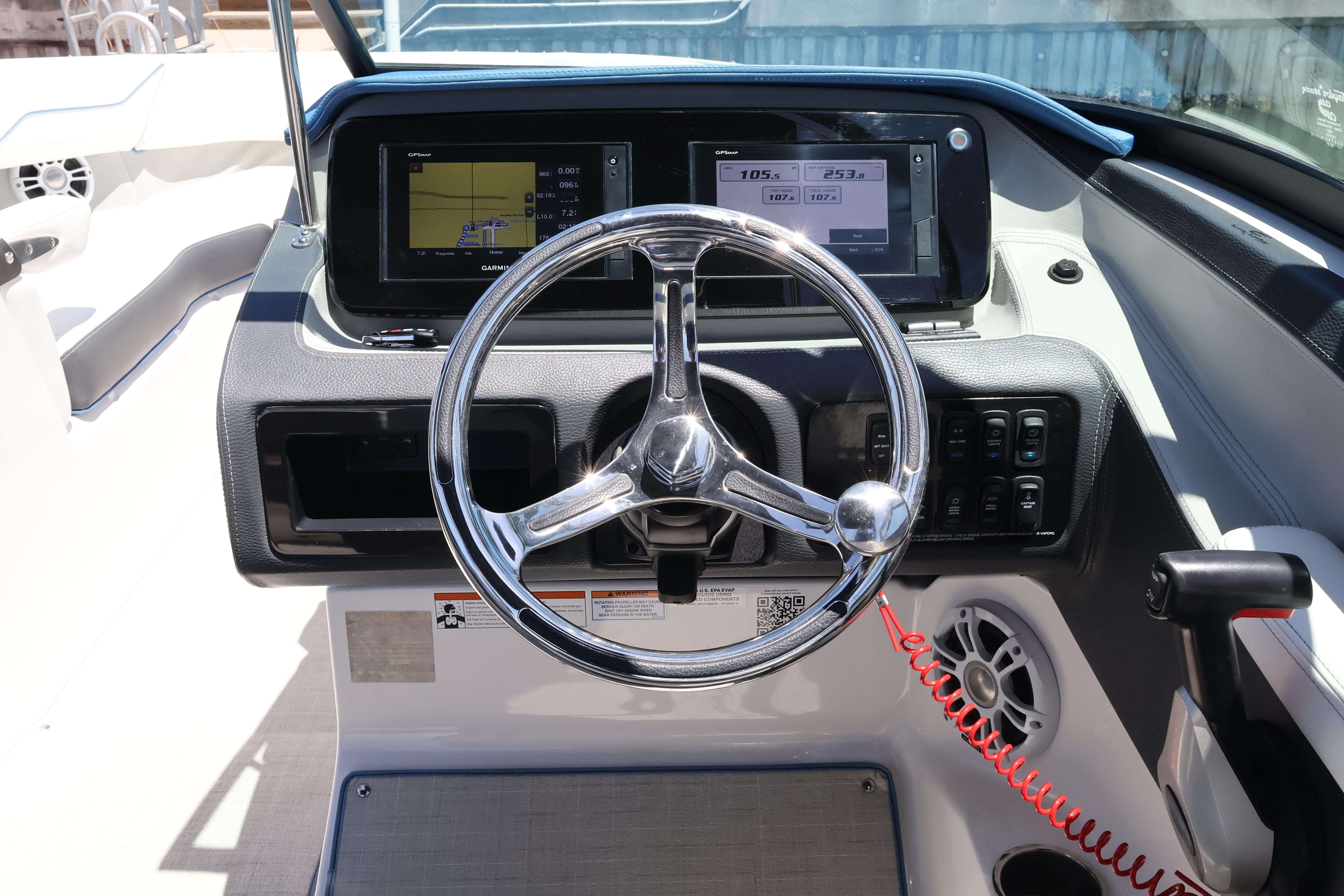 Steering console of 2020 Regal LX4 boat with digital displays and controls.