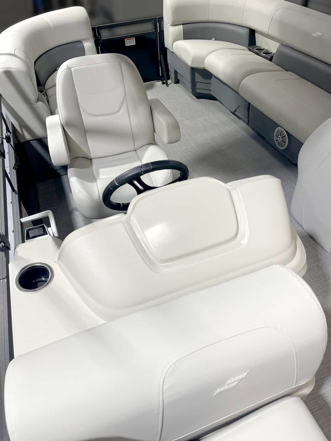 2024 Vision Marine Technologies WX Tritoon interior with plush seating and modern steering console.