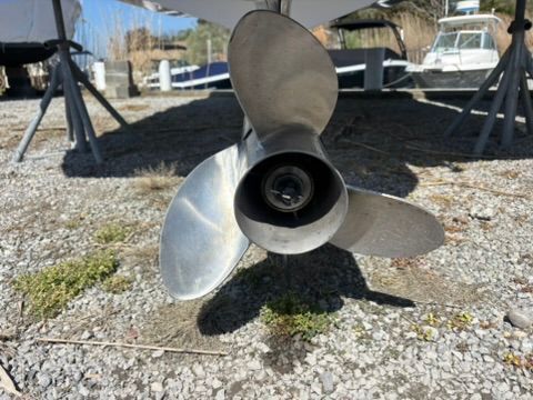 Close-up of a 2020 Cobalt SC23 propeller on gravel surface.