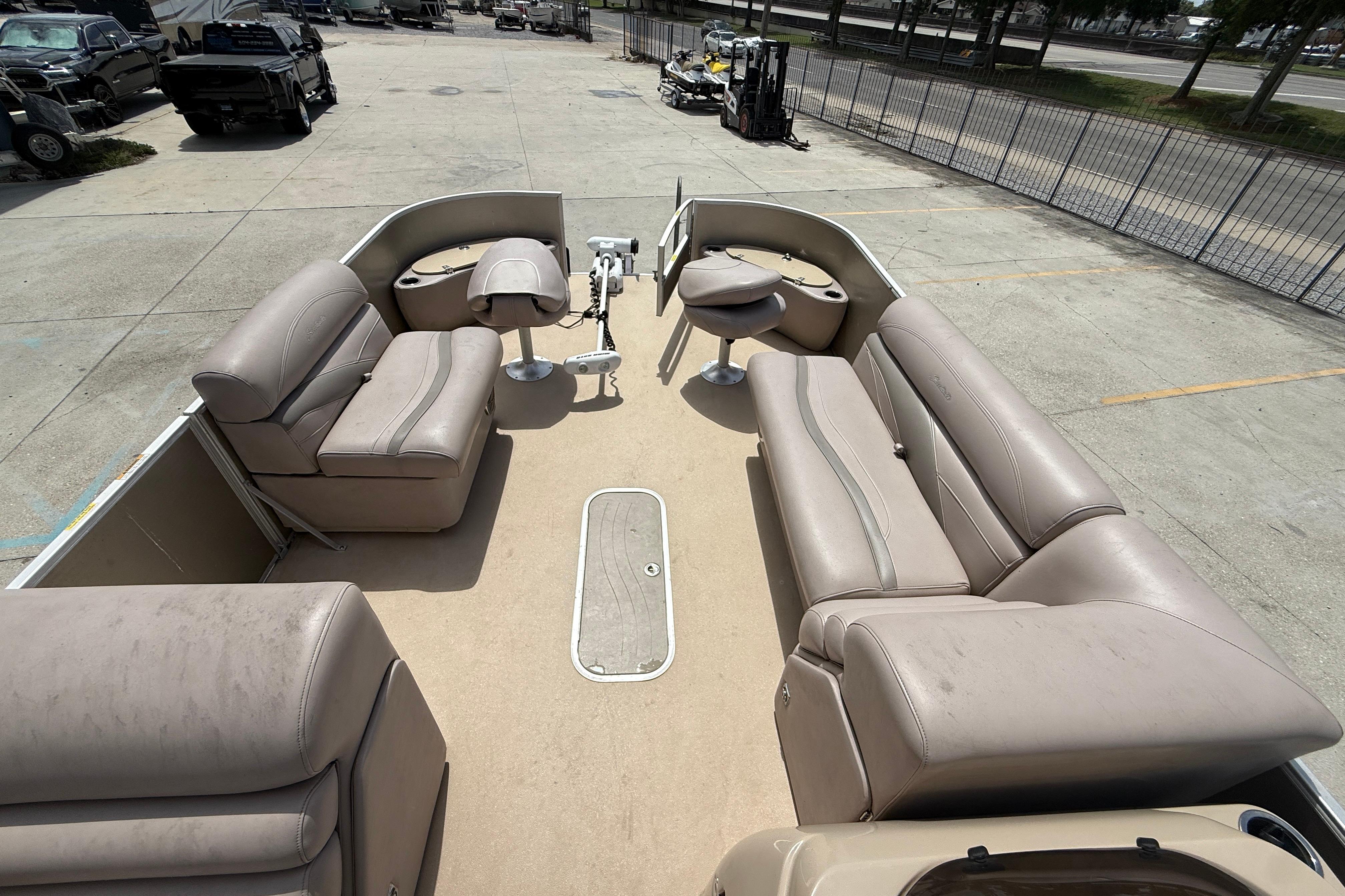 2014 Godfrey Sweetwater 2486 C pontoon boat with beige seating and spacious deck layout.