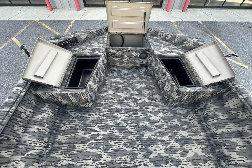 2025 Havoc 1860 boat interior with camo design and open storage compartments.