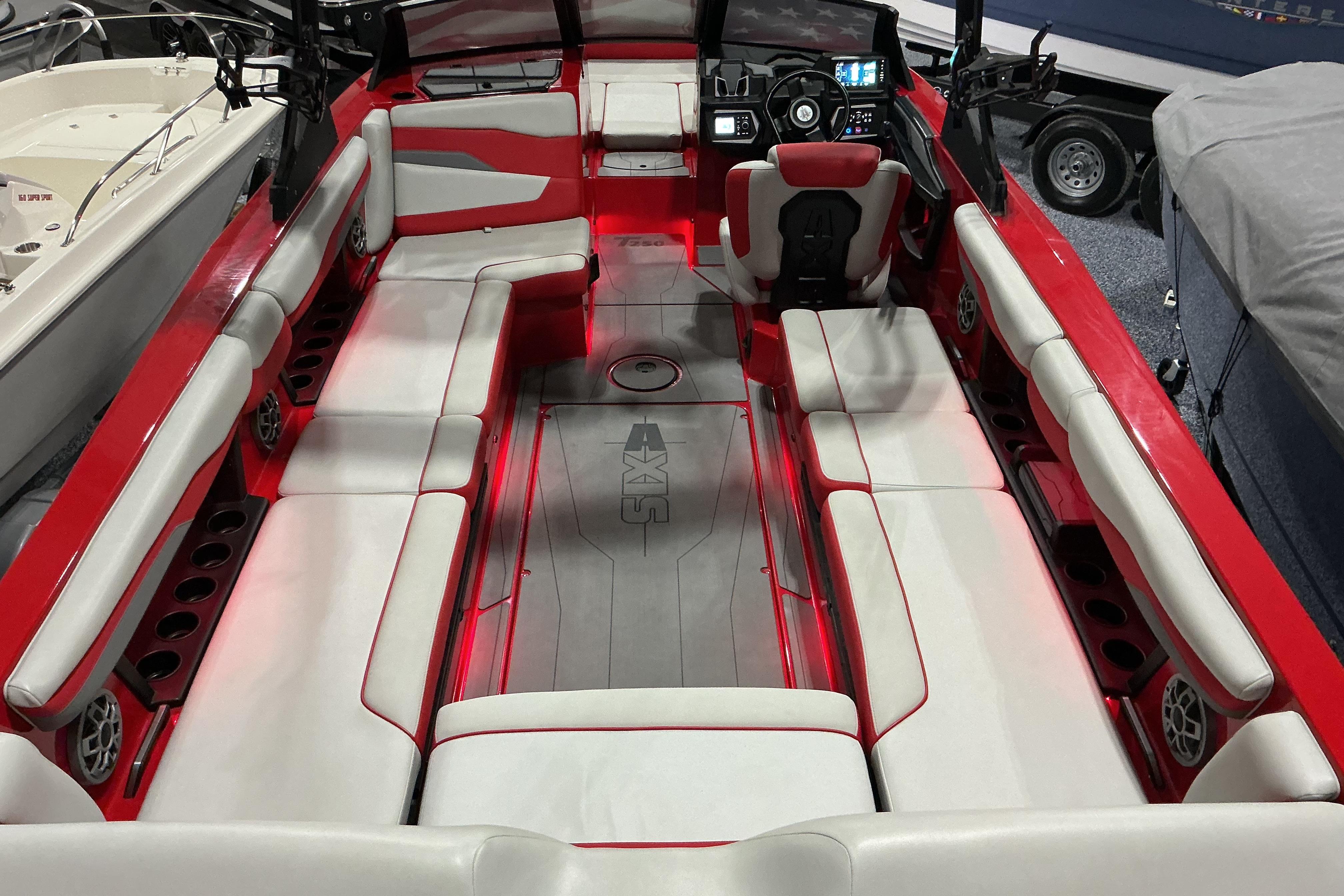 2022 Axis T250 boat interior with red and white seating, modern dashboard, and spacious layout.