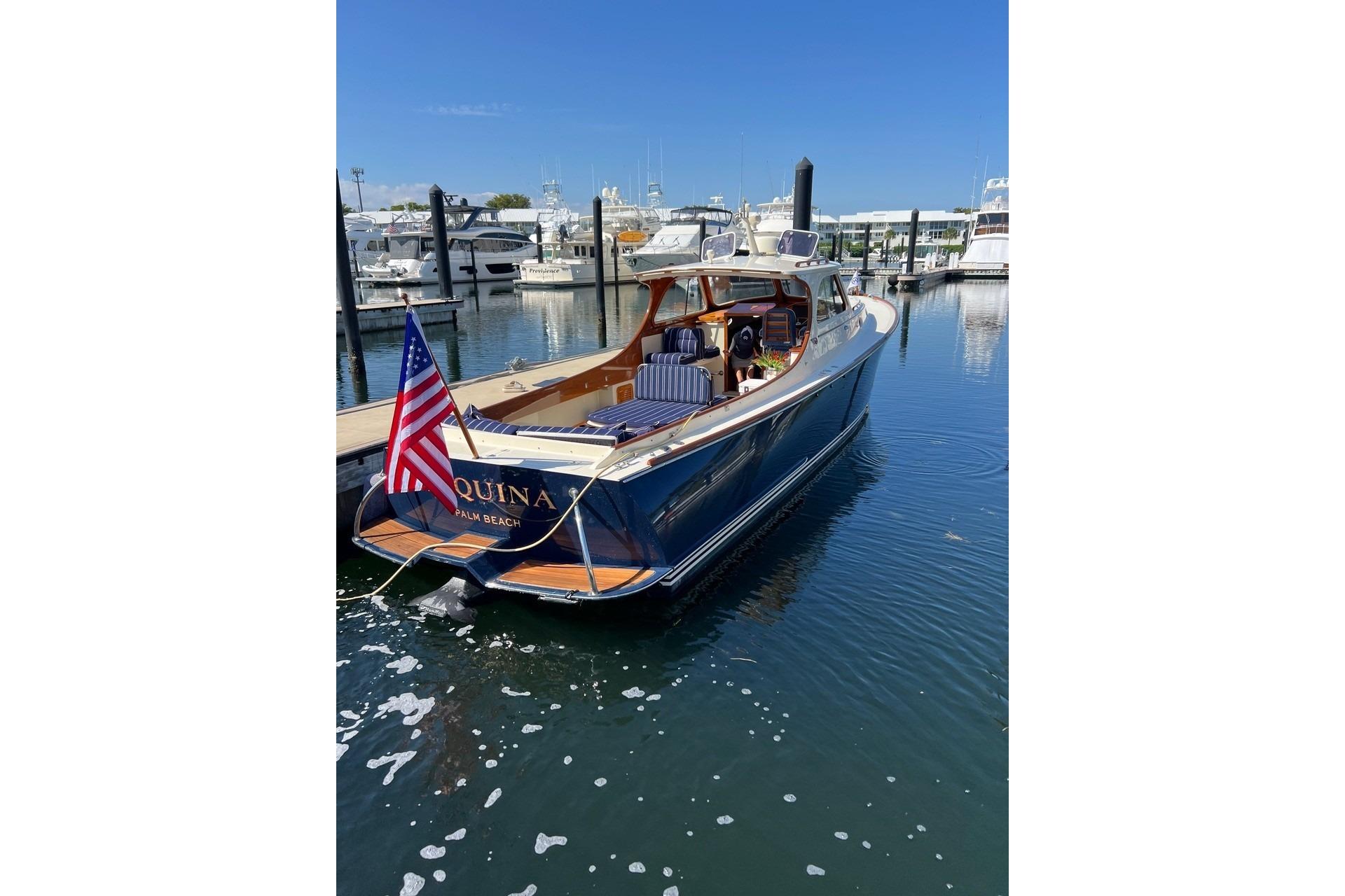 2001 Hinckley Picnic Boat 36 Classic docked in a marina, displaying an American flag.