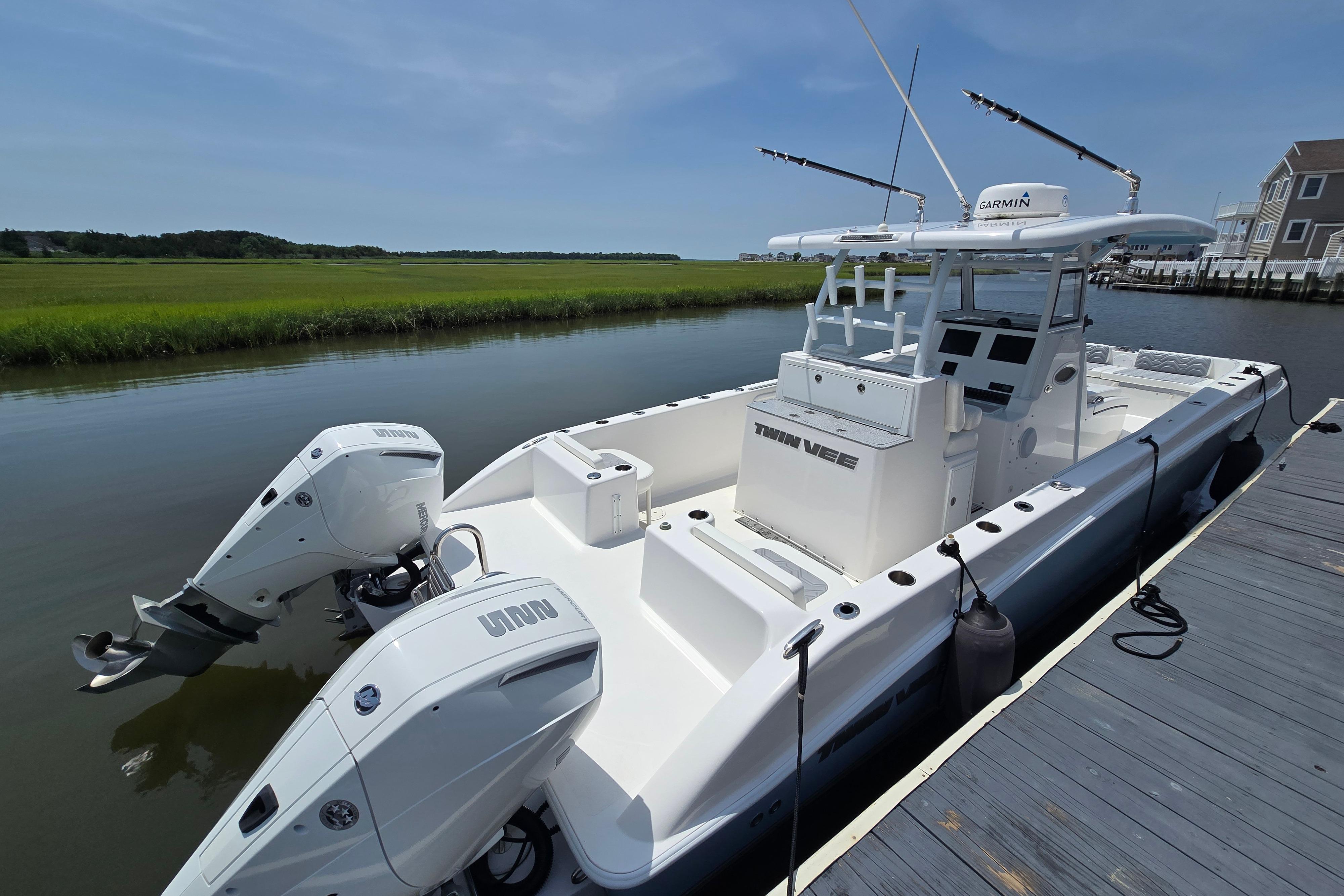 2021 Twin Vee 280 GFX CC boat docked by a serene waterfront.
