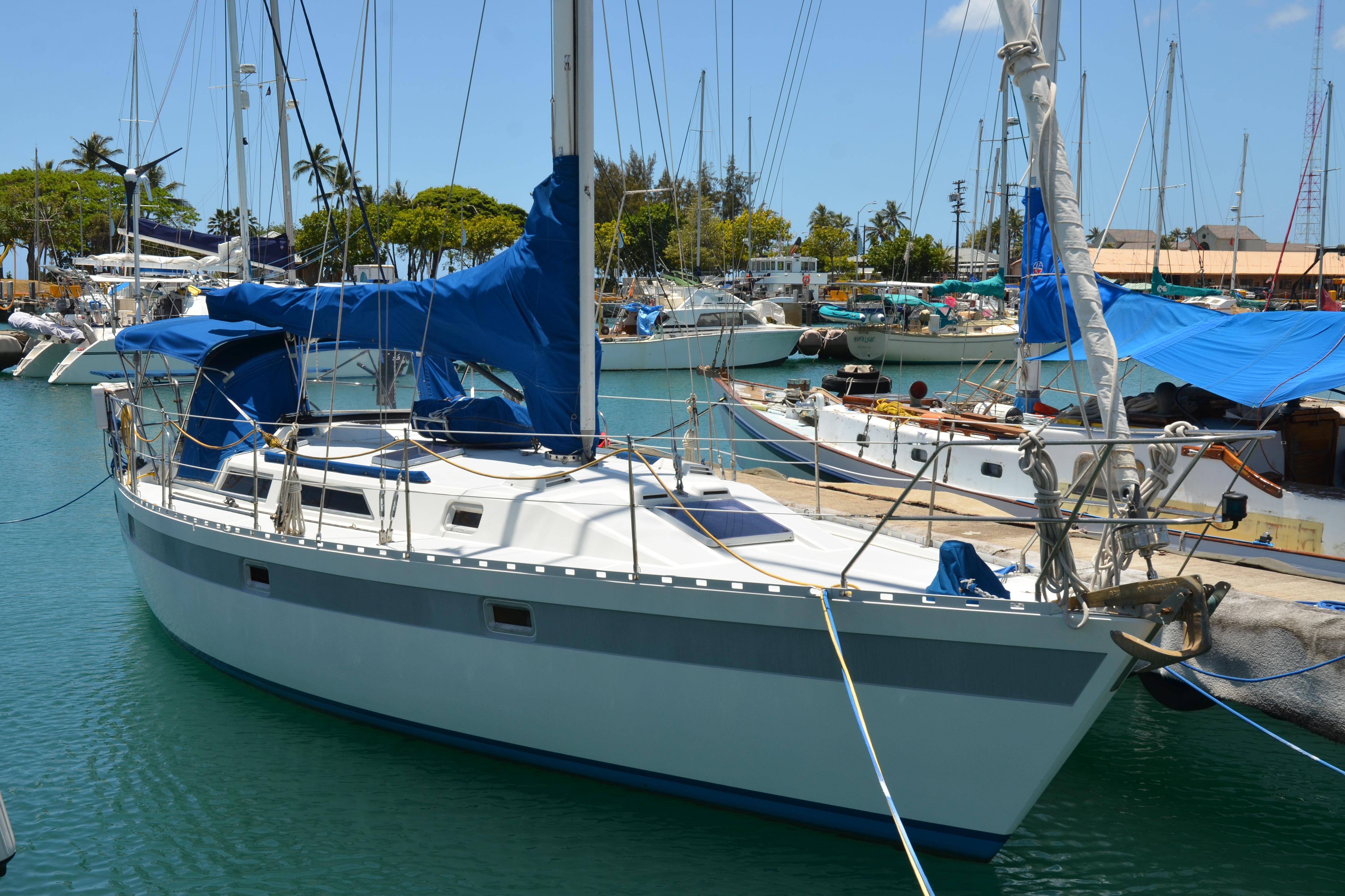 1987 Norseman 400 sailboat docked in a marina, surrounded by other boats.