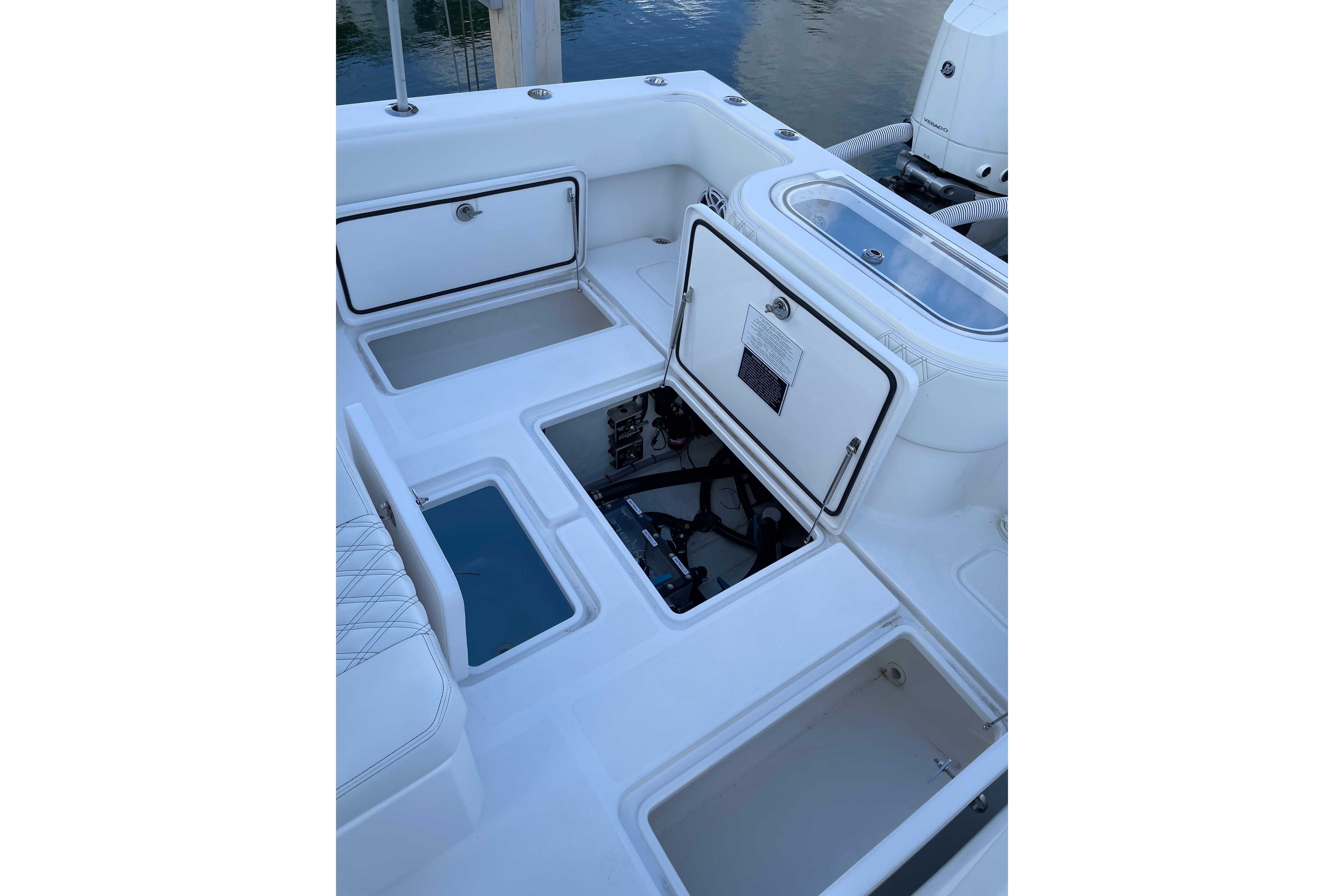 2024 Invincible 36 Open Fisherman boat deck with storage compartments open.
