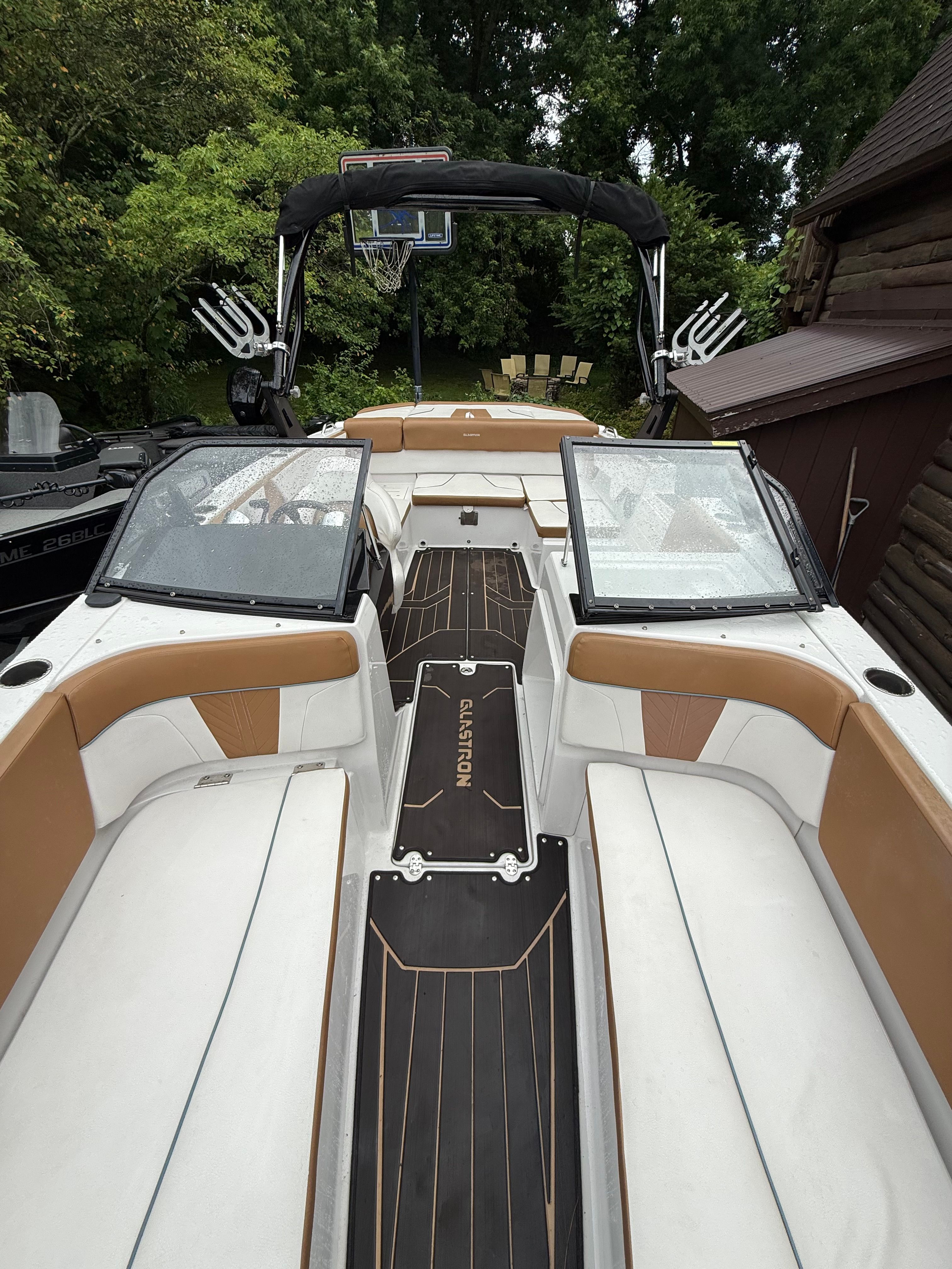 2019 Glastron GTDW 225 with white and brown interior, two windshields, and a black wakeboard tower.