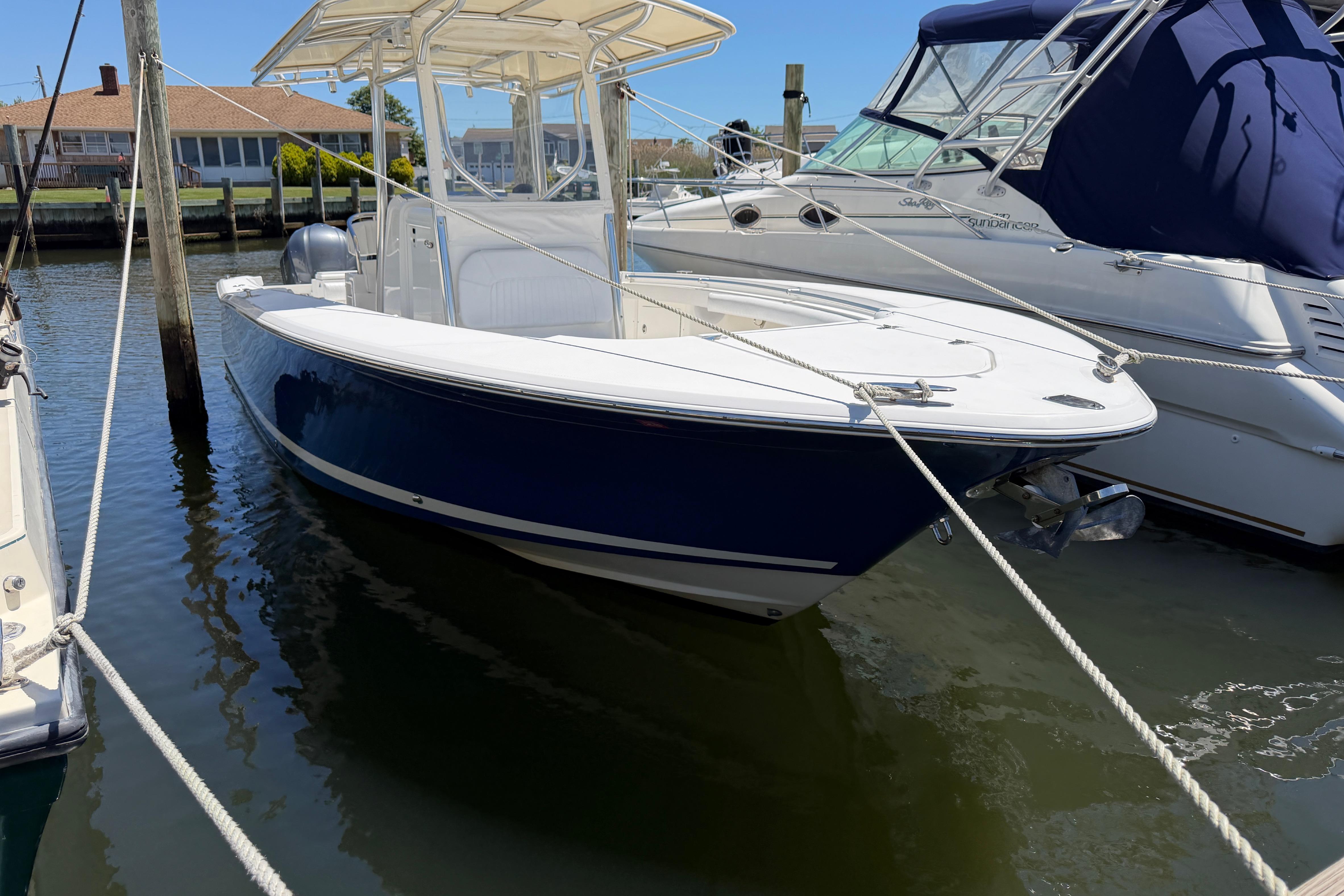 2006 Southport 26 Center Console boat docked in marina, sunny day.