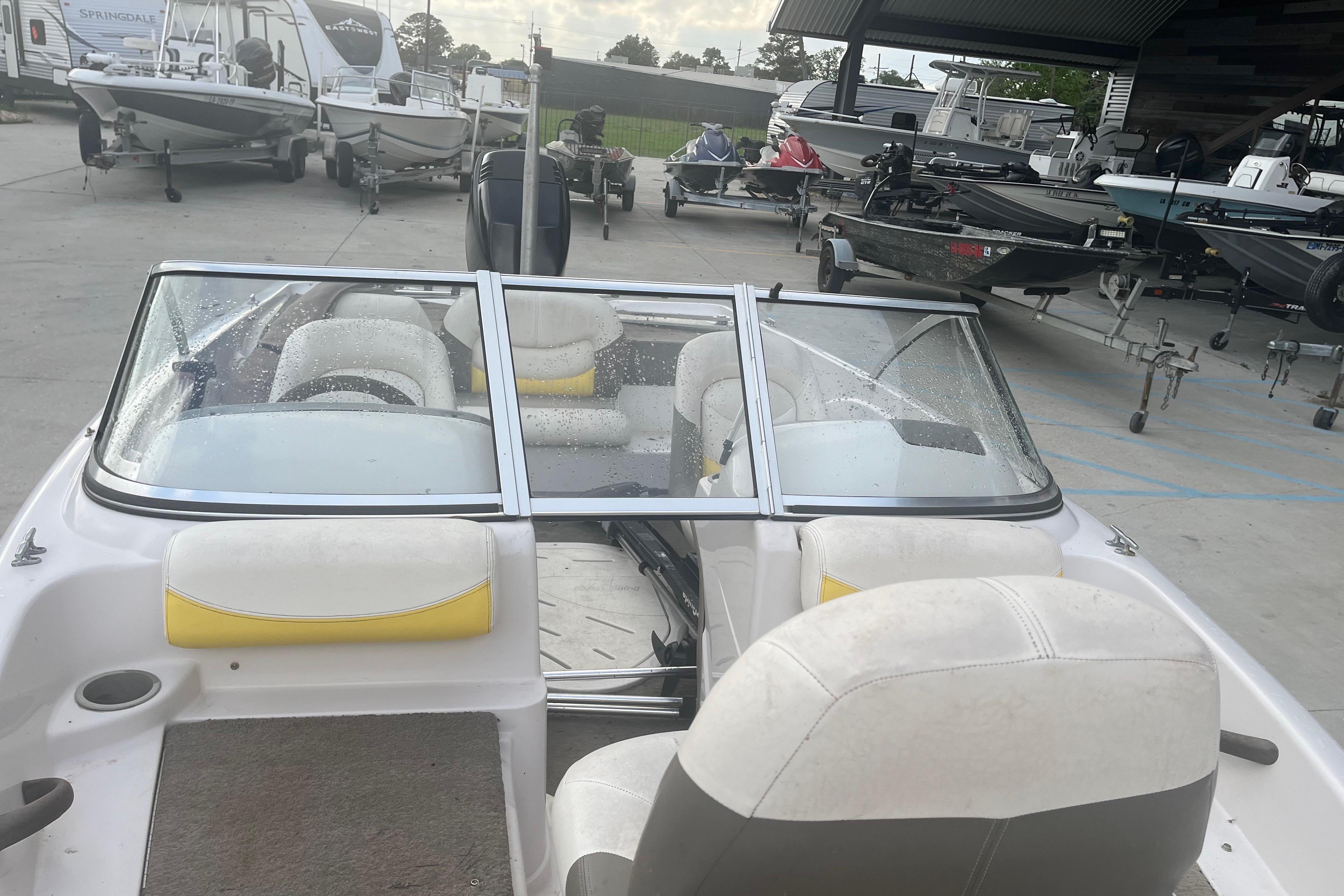 2006 Nitro 189 Sport boat with white and yellow interior, parked in a marina.