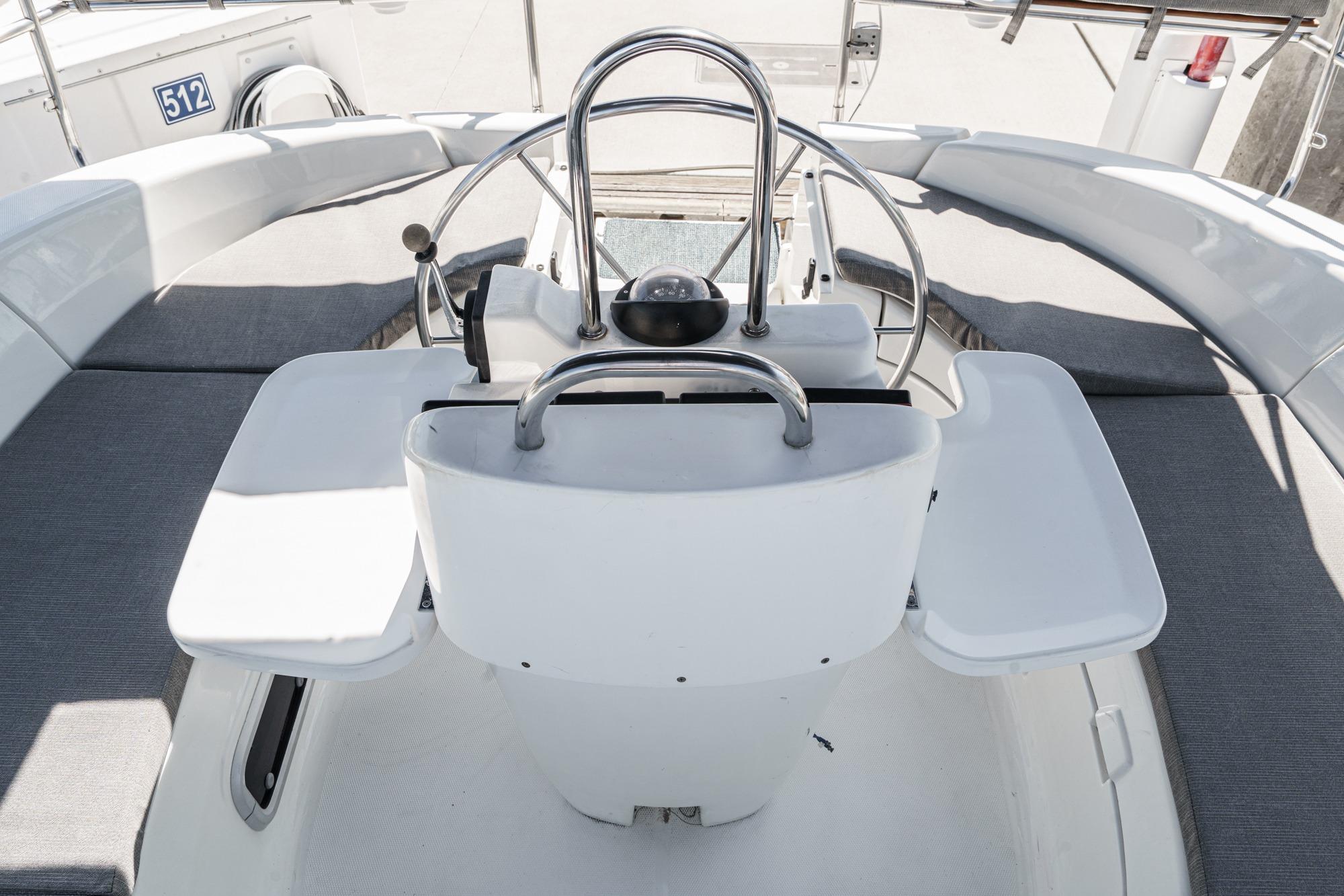 Cockpit of 1996 Hunter 376 sailboat with steering wheel and seating area.