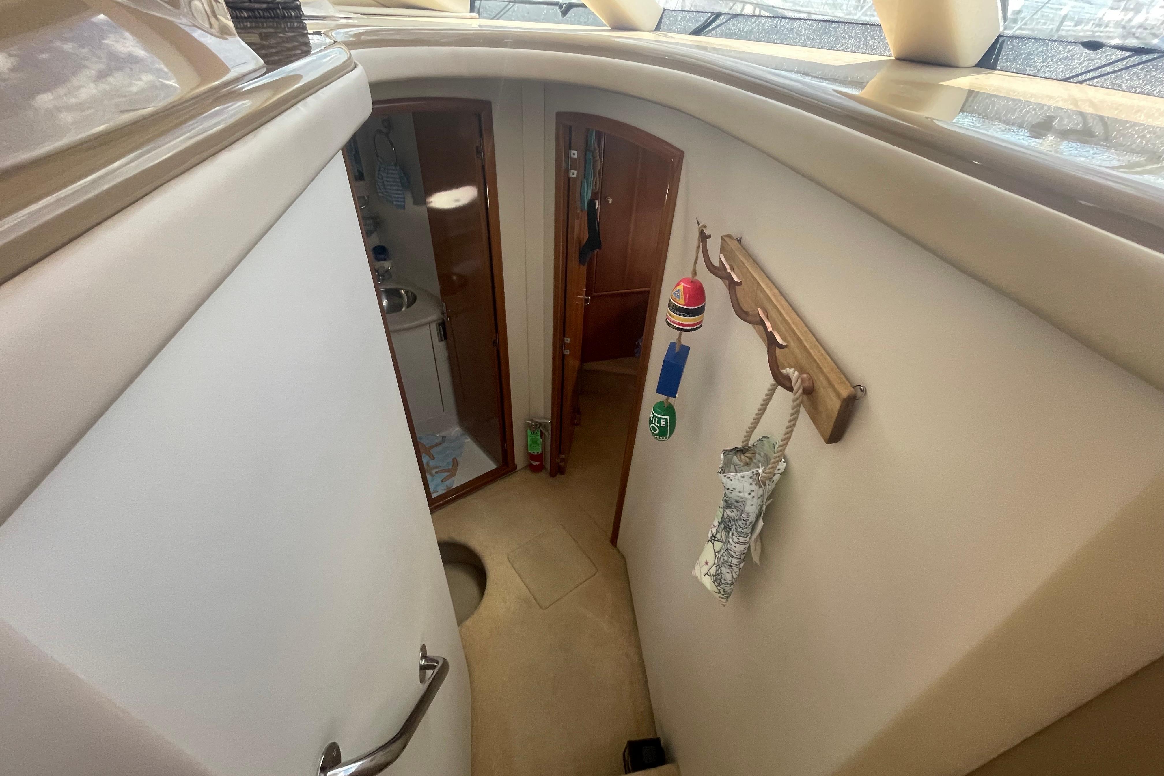 Interior of 2002 Carver 410 Sport Sedan yacht, featuring hallway and bathroom entrance.