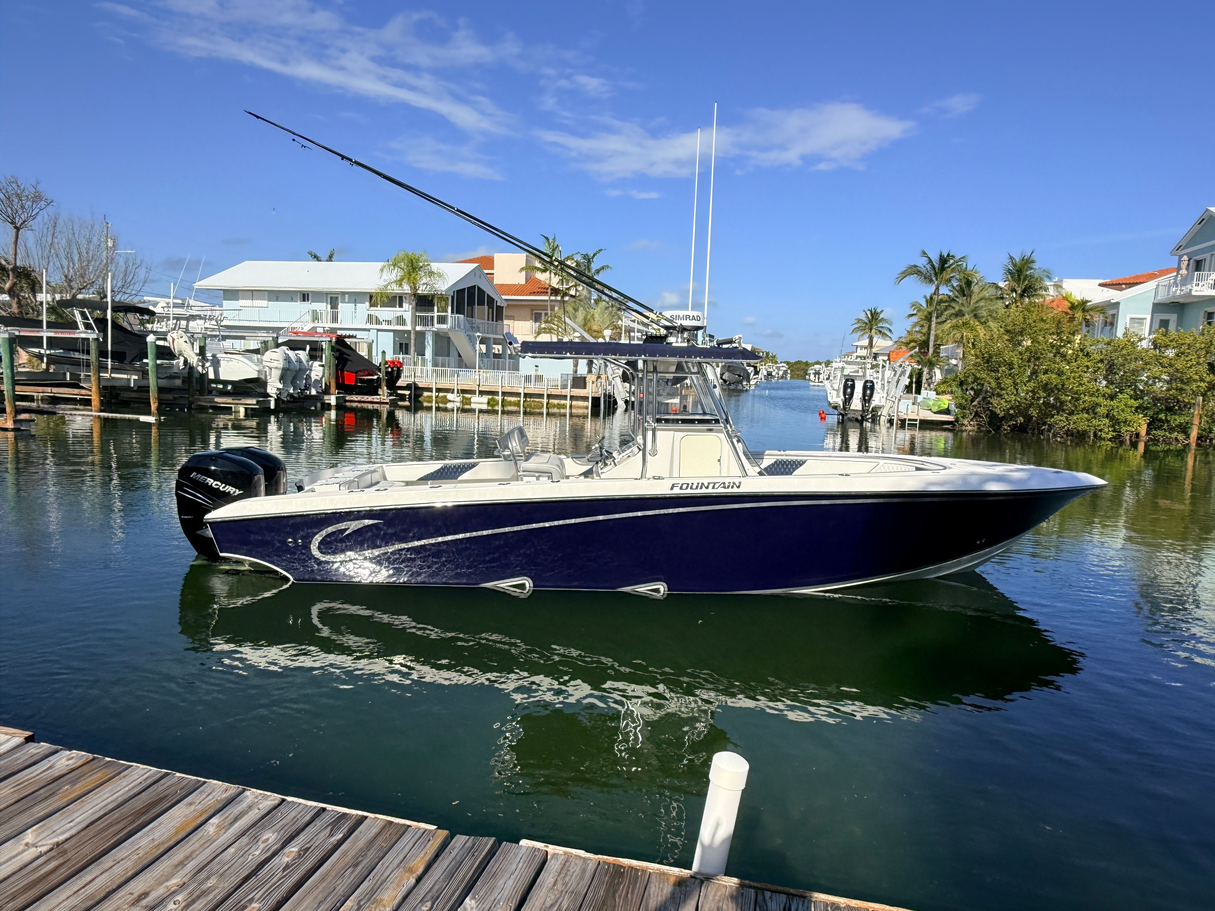 2007 Fountain 32 Center Console boat docked in harbor.