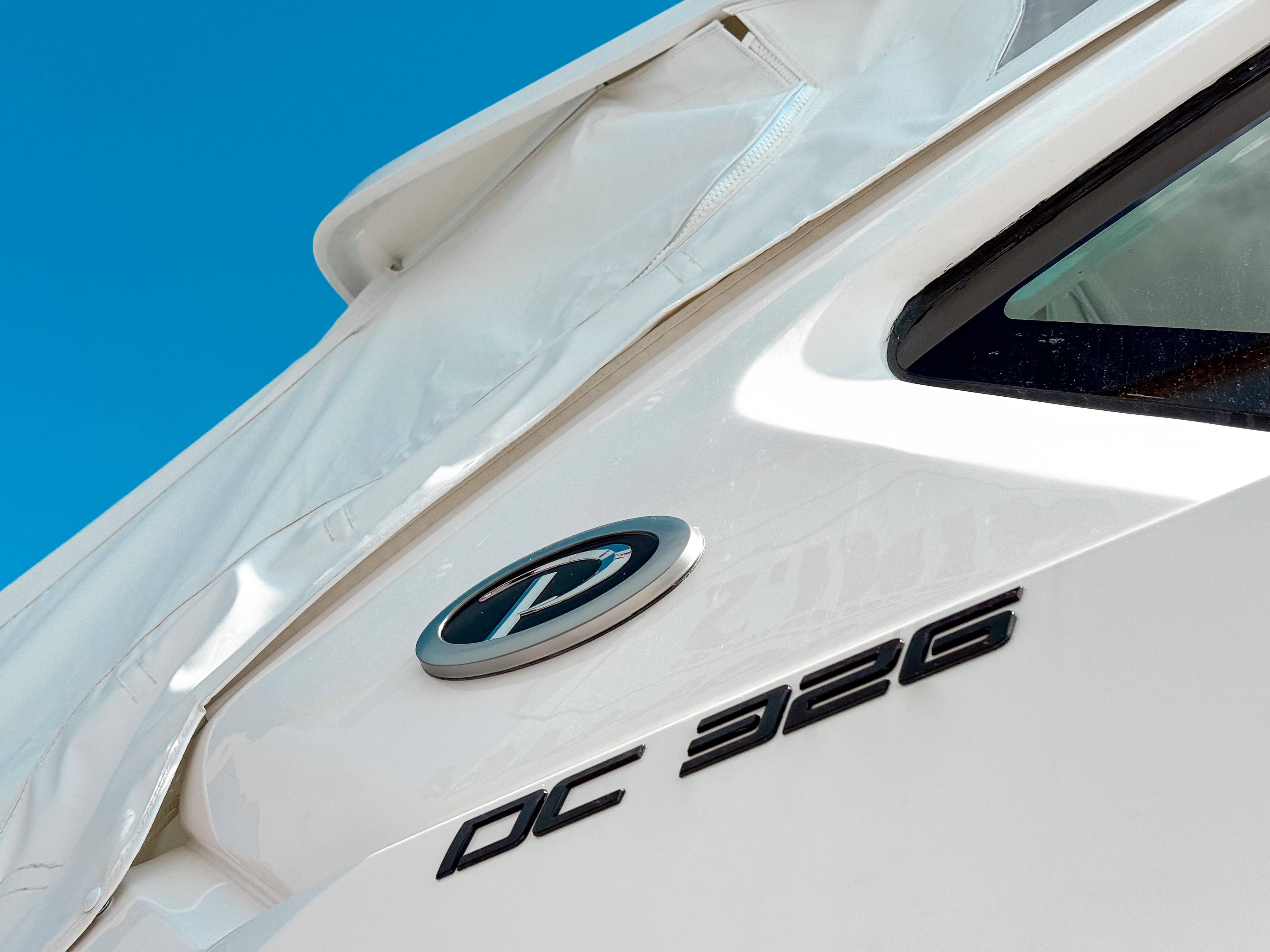 2025 Pursuit DC 326 Dual Console boat, close-up view with logo and model name.