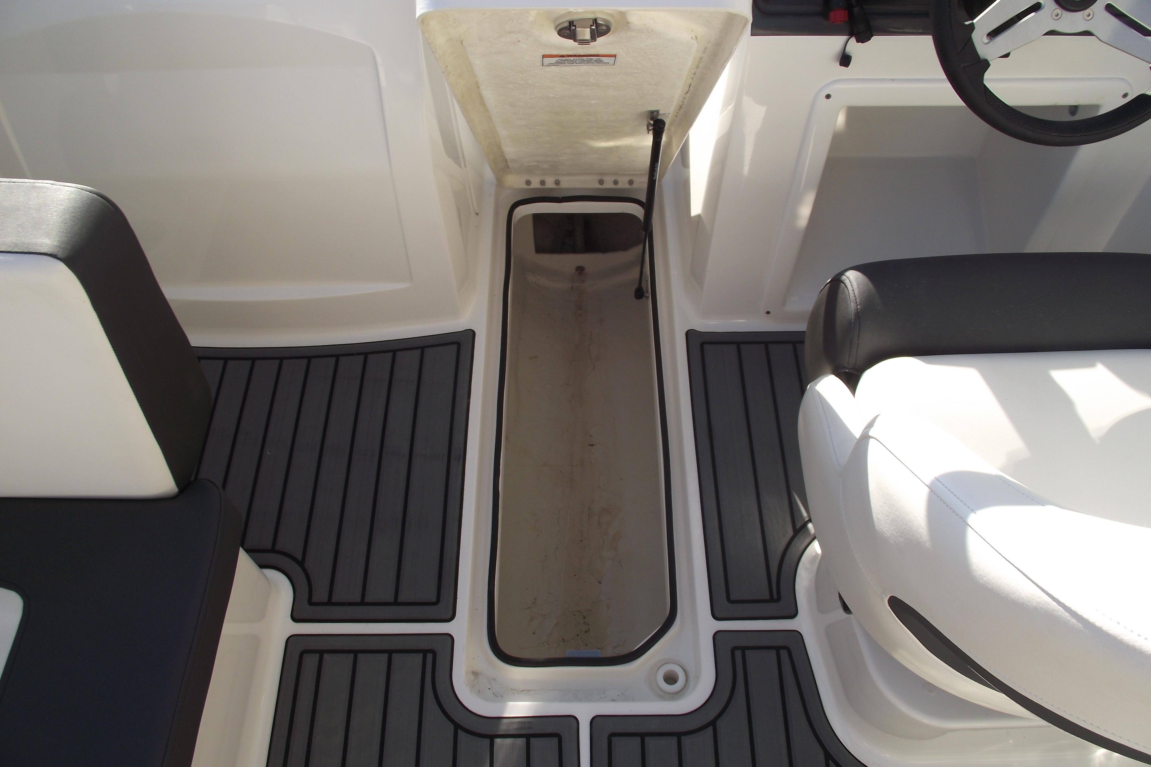 2022 Bayliner VR4 Bowrider OB interior with open storage compartment and seating.
