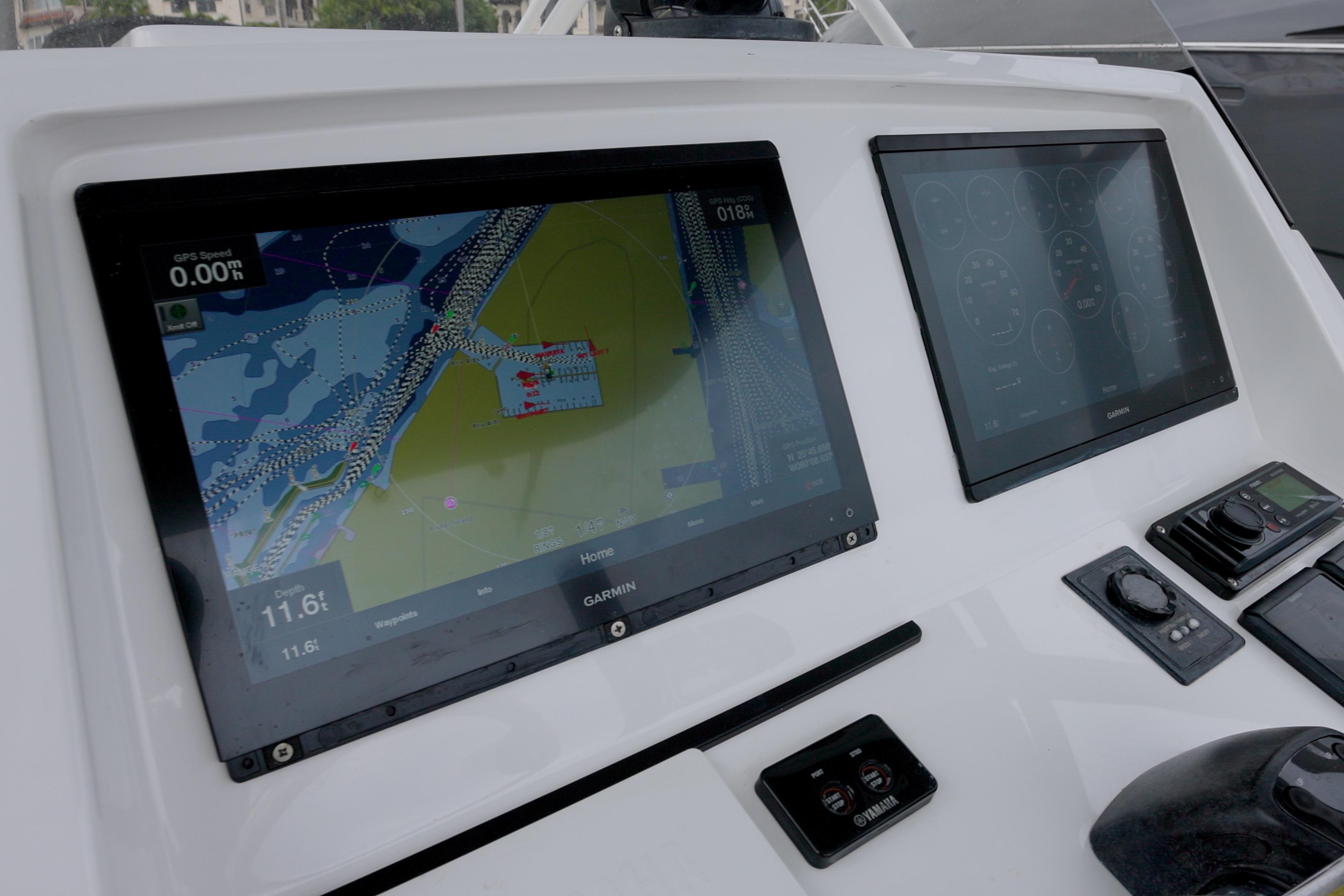 2014 Intrepid 327 Cuddy boat dashboard with Garmin navigation screens.
