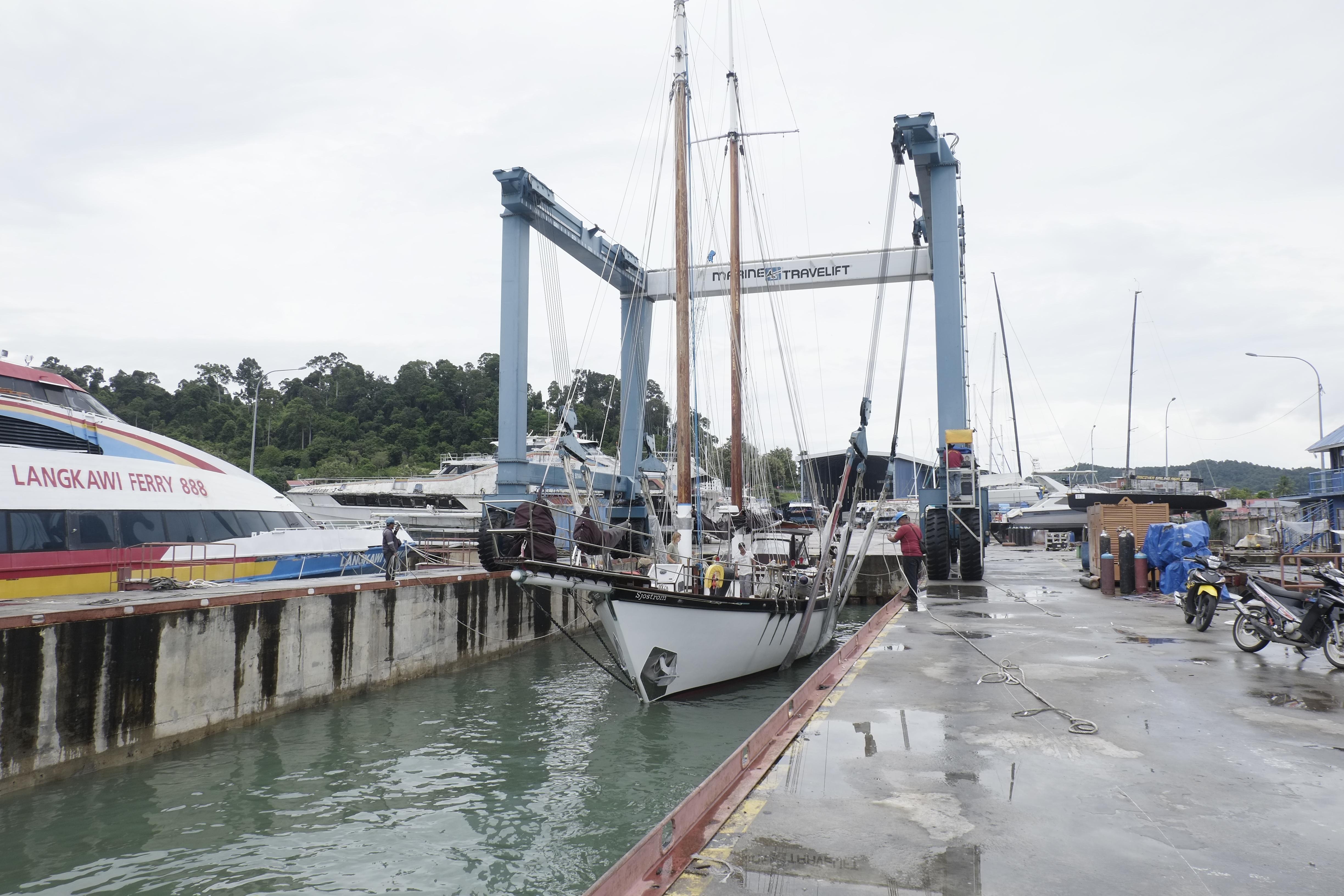 Custom Bud Macintosh schooner, 2006, docked at a shipyard with a travel lift nearby.