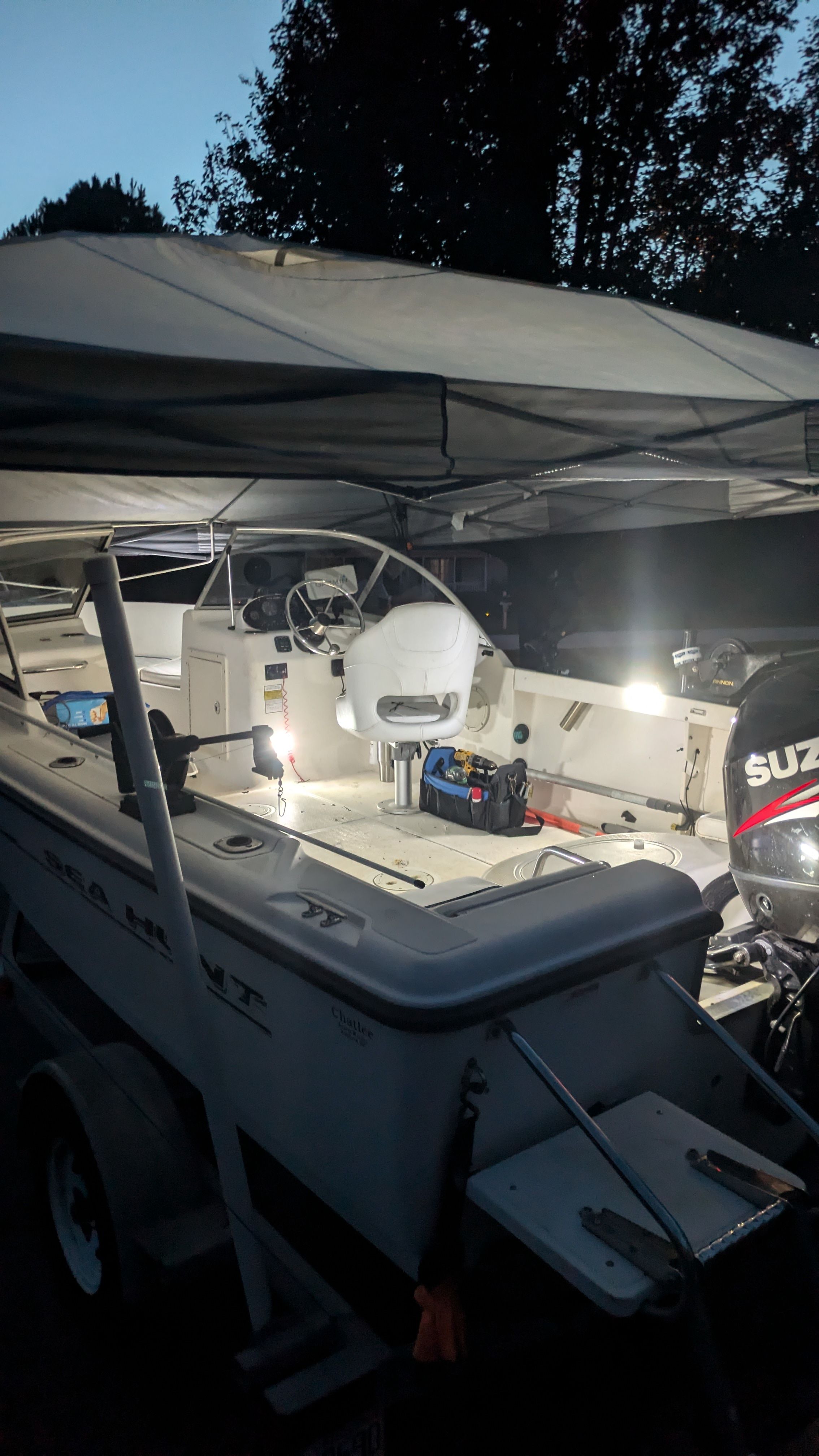 Sea Hunt Escape 200 boat at dusk with Suzuki engine.
