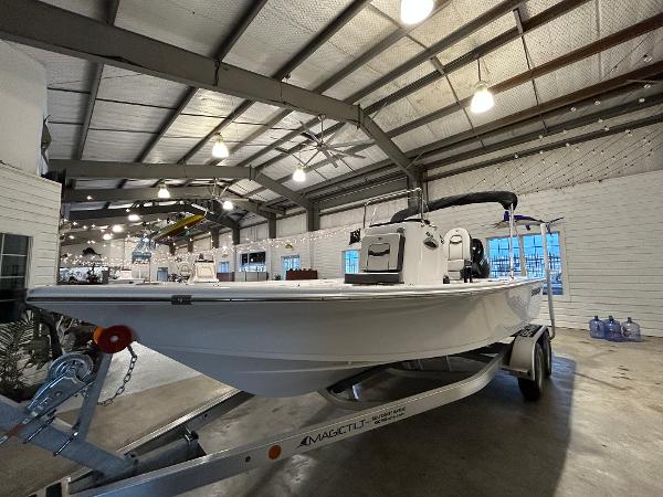 2025 Sea Pro 210 Bay boat on trailer in showroom.