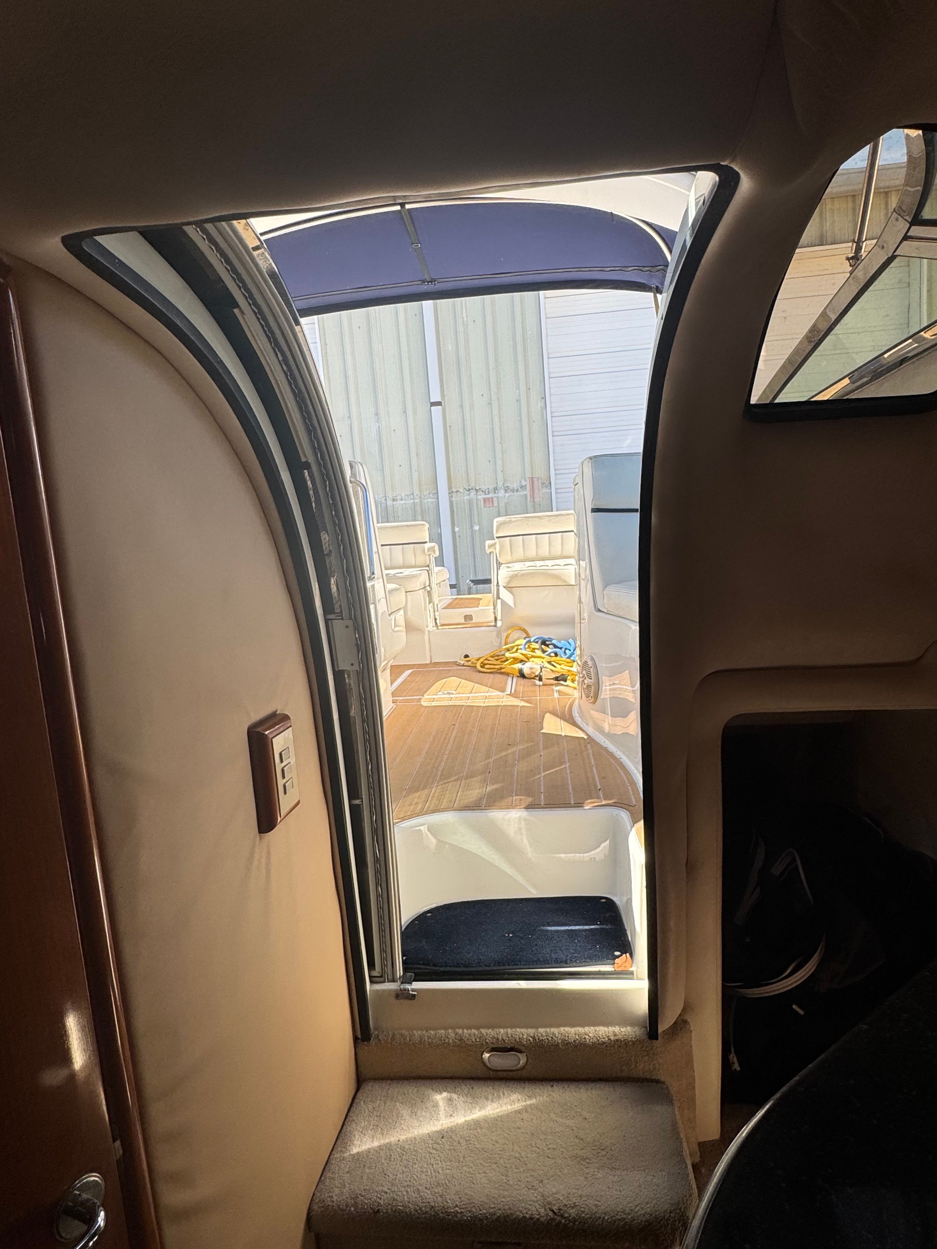 View from inside a Cobalt 360 looking out to the deck with seating and sunshade.
