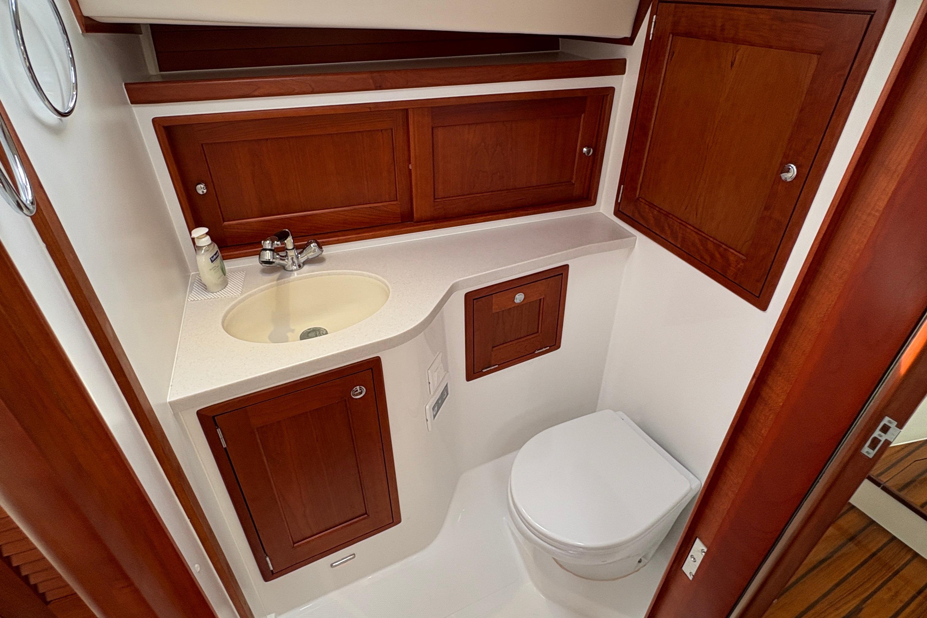 Luxurious 2023 MJM 35 yacht bathroom with wooden cabinetry and modern fixtures.