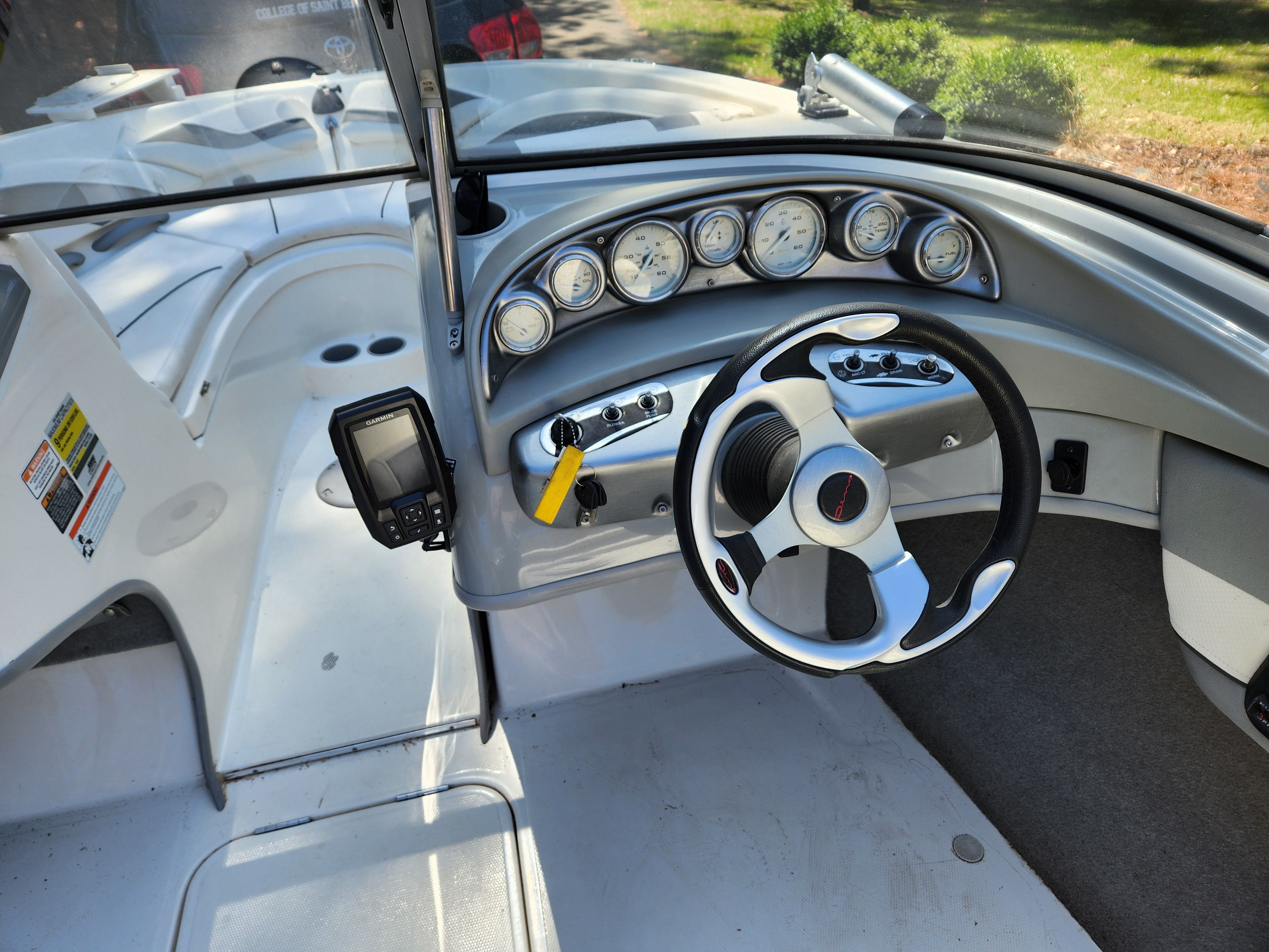 The image shows the cockpit of a 2009 Bayliner 194SF with a modern dashboard.
