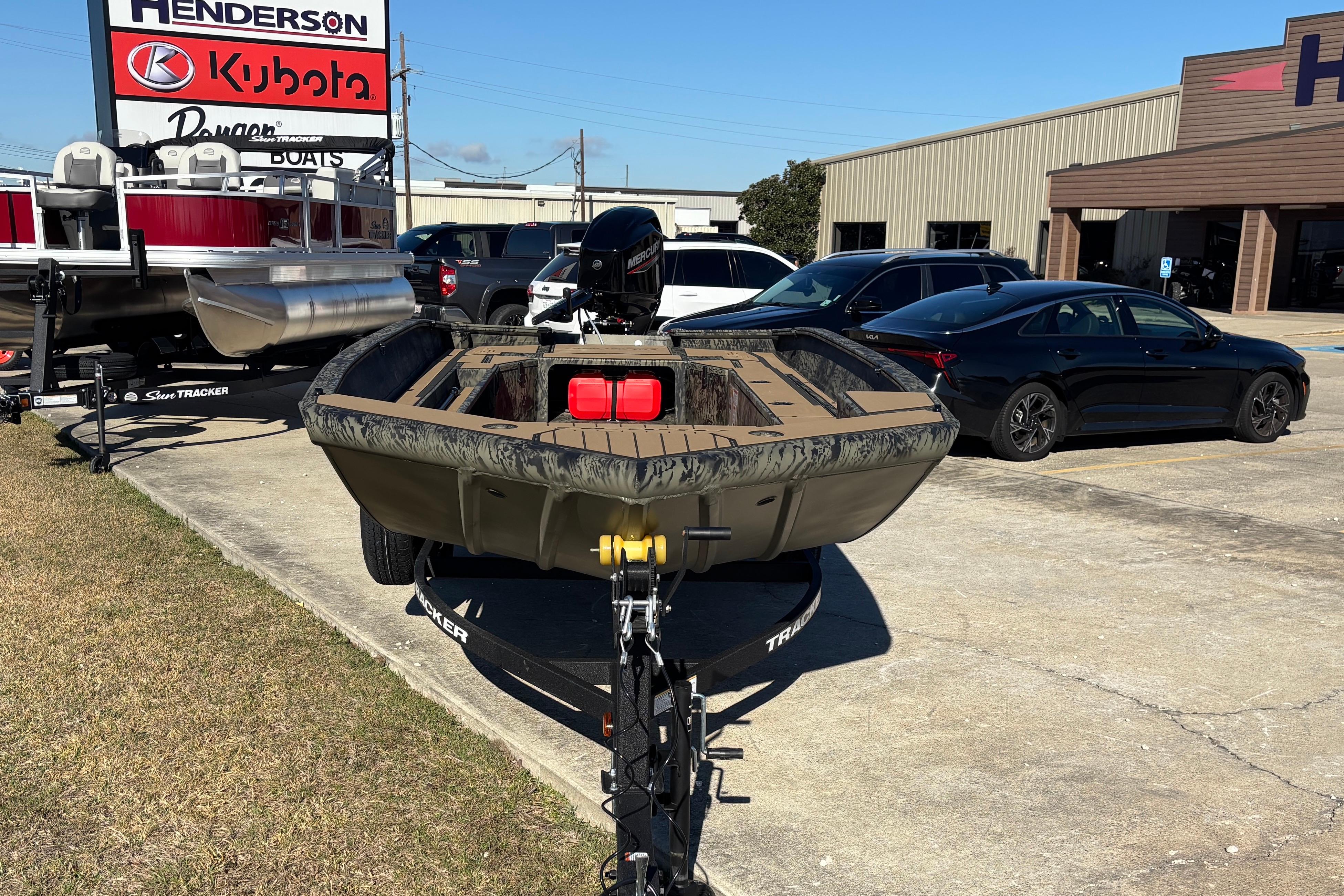 2026 Tracker Grizzly 1756 T Marsh boat on trailer at dealership parking lot.