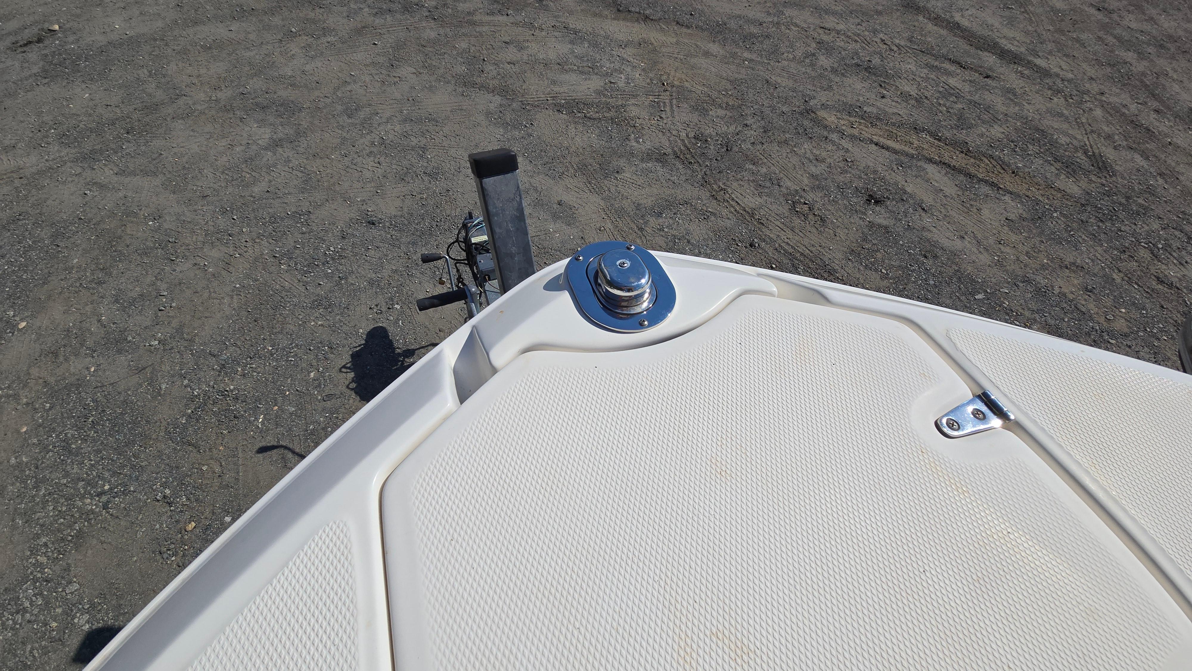 Bow of 2018 Chaparral 224 Sunesta boat on a trailer, parked on gravel.