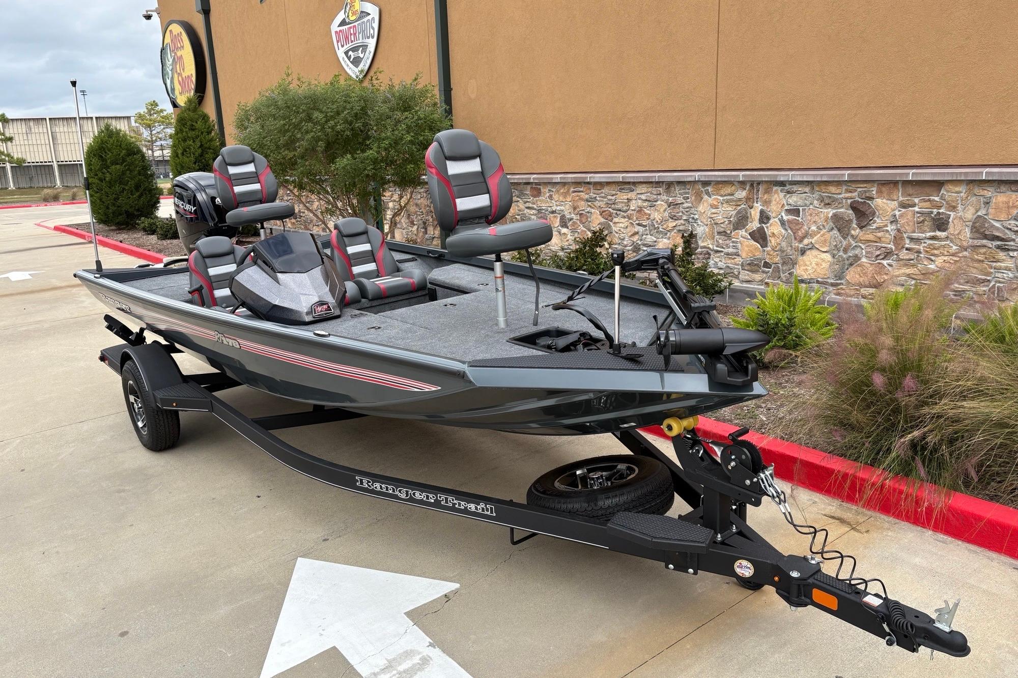 2026 Ranger RT178 fishing boat on trailer, parked outdoors near a stone wall.