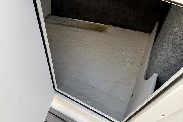 Storage compartment in a 2021 Chaparral 21 SSi boat, featuring a clean interior.