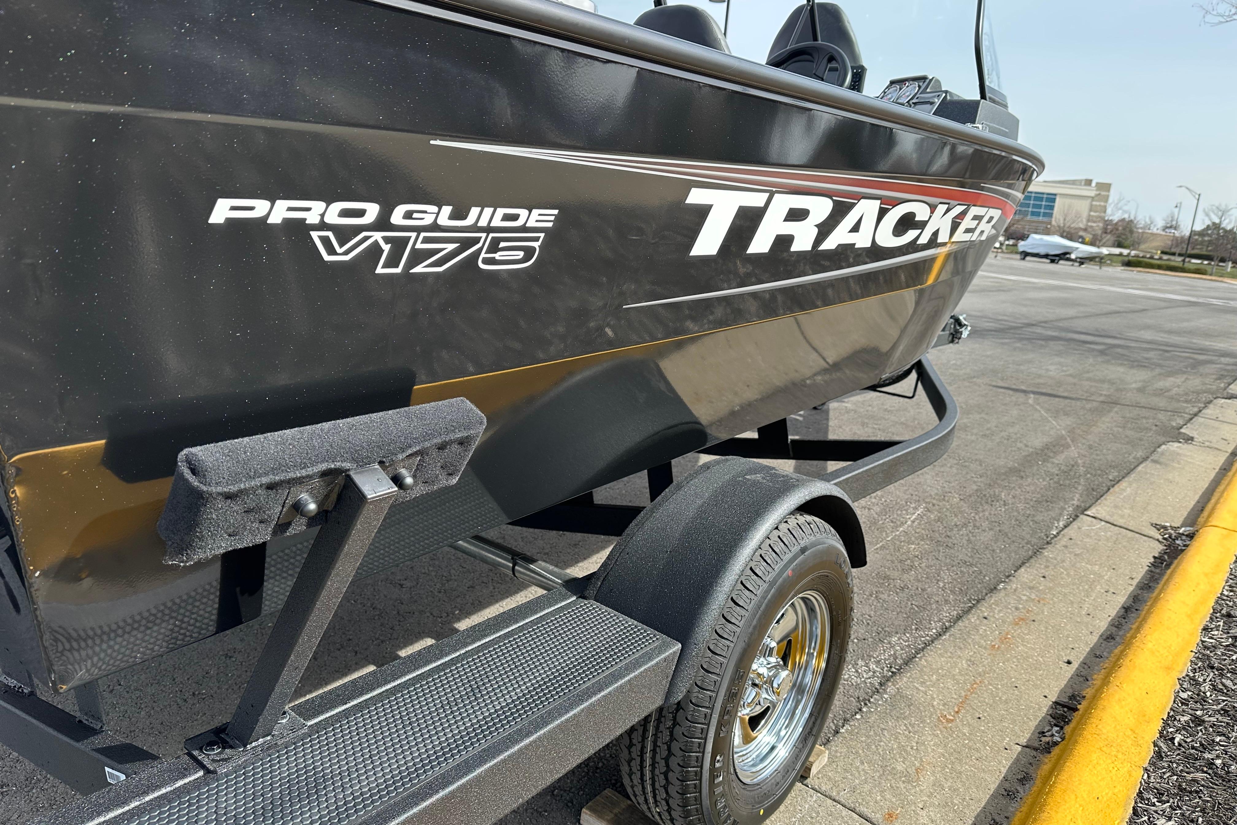 2026 Tracker Pro Guide V-175 Combo boat on trailer, parked on pavement.