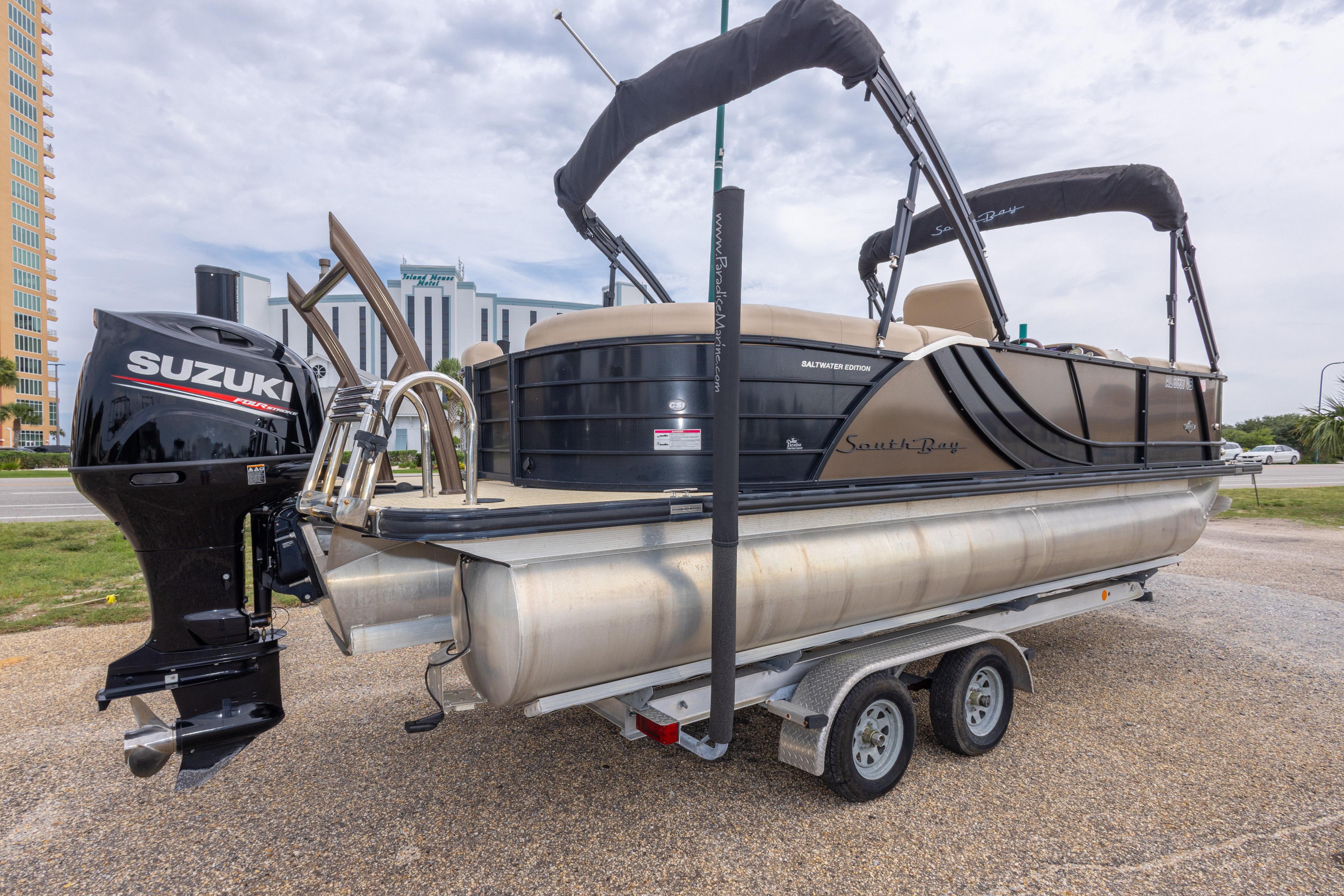 2018 South Bay 523RS pontoon boat with Suzuki outboard motor on a trailer.