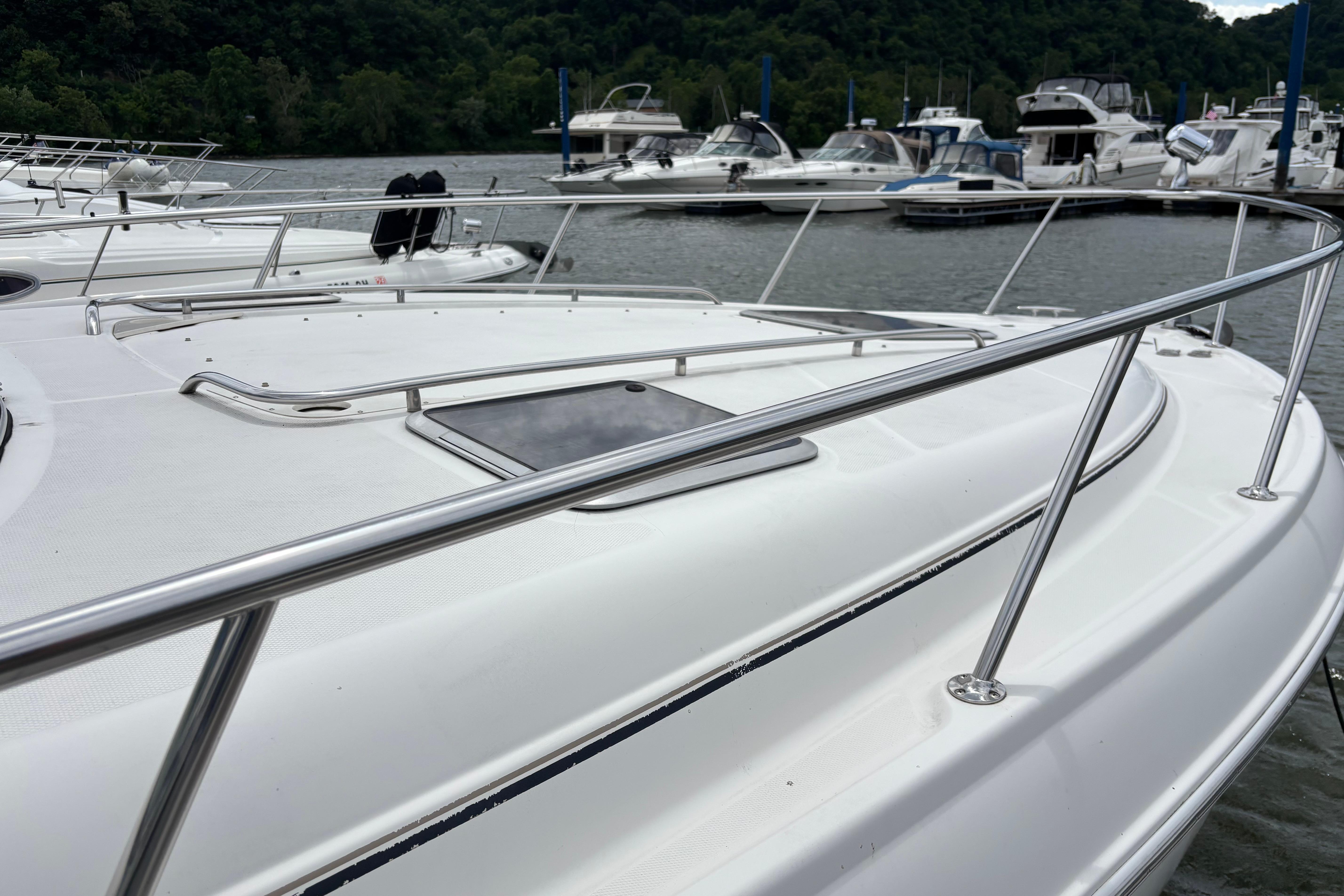 2004 Chaparral Signature 330 yacht docked at marina with other boats.