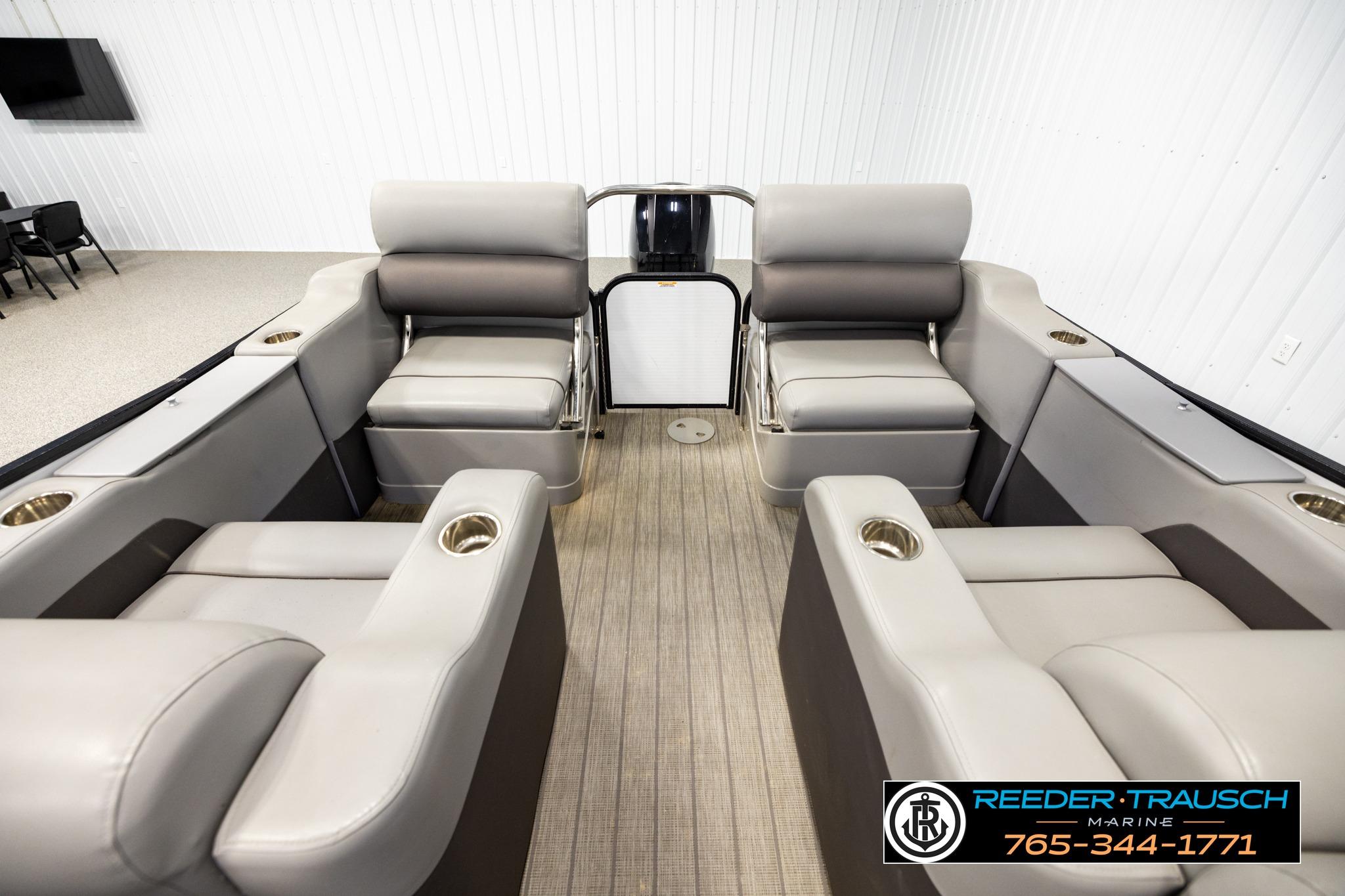2019 Manitou Oasis SR VP pontoon boat interior with plush seating and cup holders.