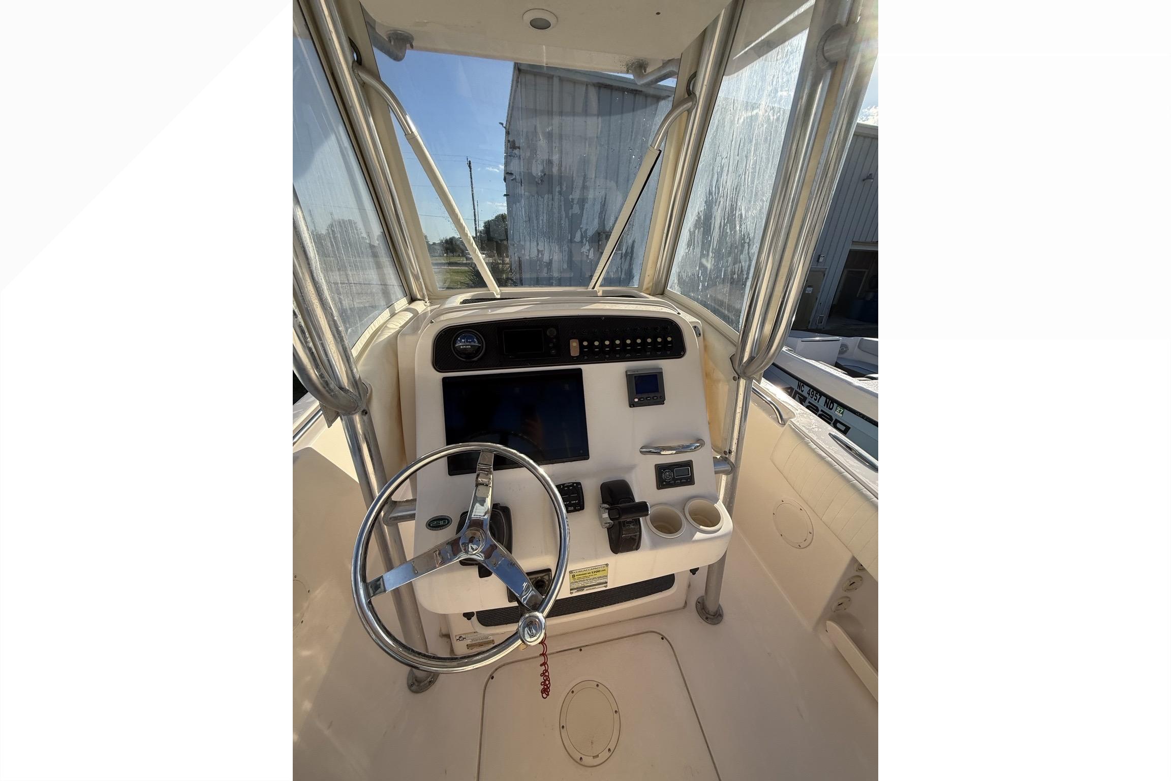 2011 Grady-White Fisherman 230 boat console with steering wheel and navigation controls.