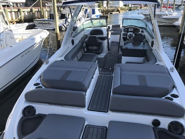 2020 Rinker 29QX BR boat with spacious seating docked at a marina.