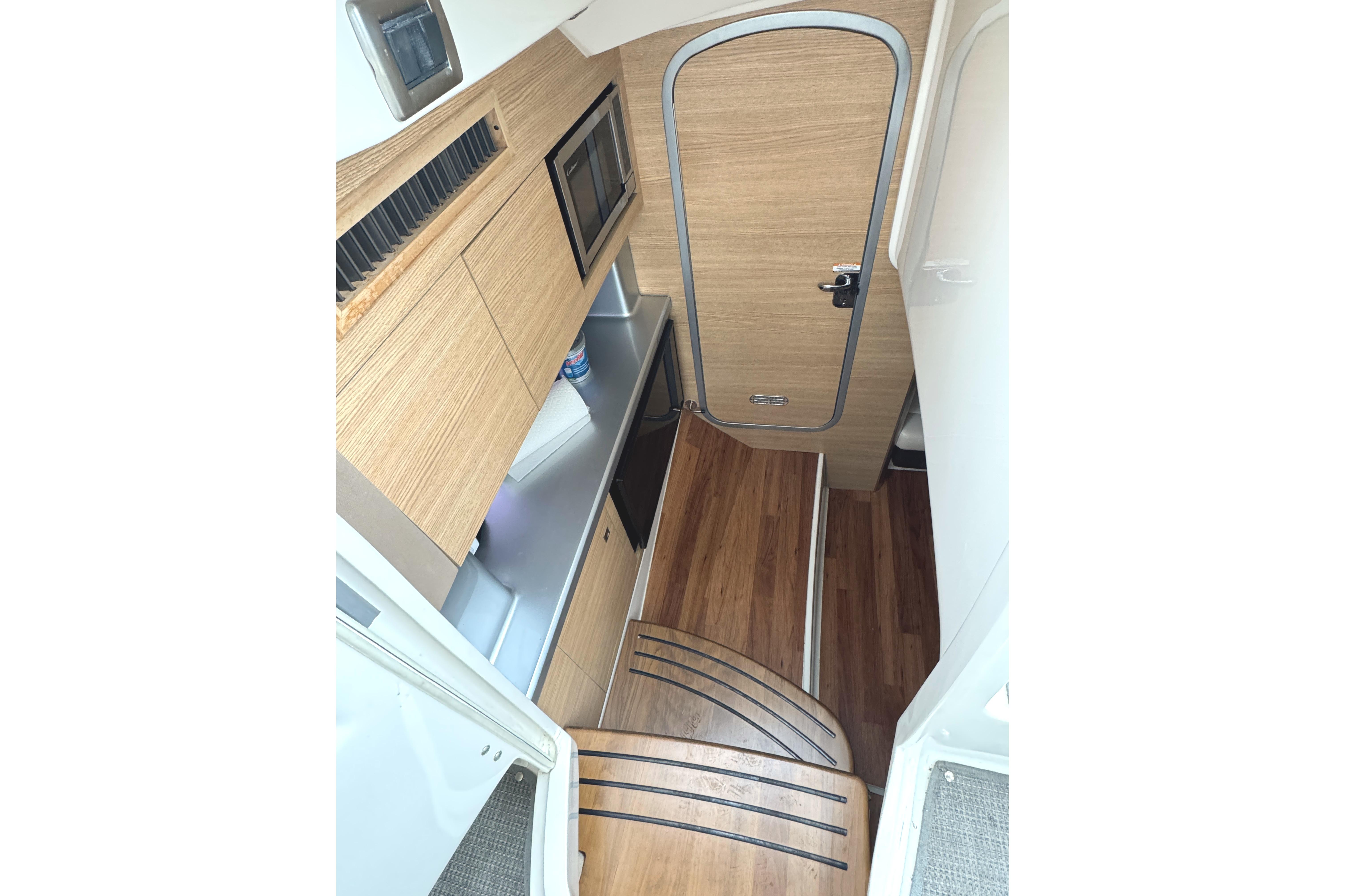 2012 Chaparral 327 SSX cabin interior with wood finish and modern amenities.