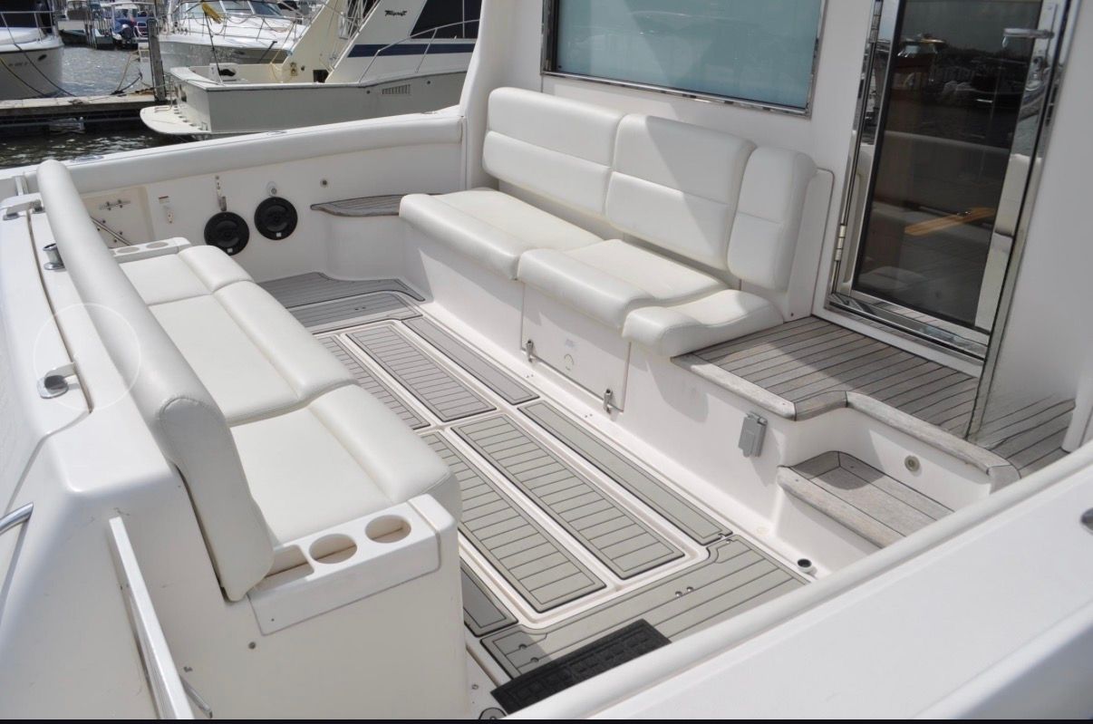 The image shows the cockpit of a 2005 Tiara Yachts 5200 Sovran with white seating.