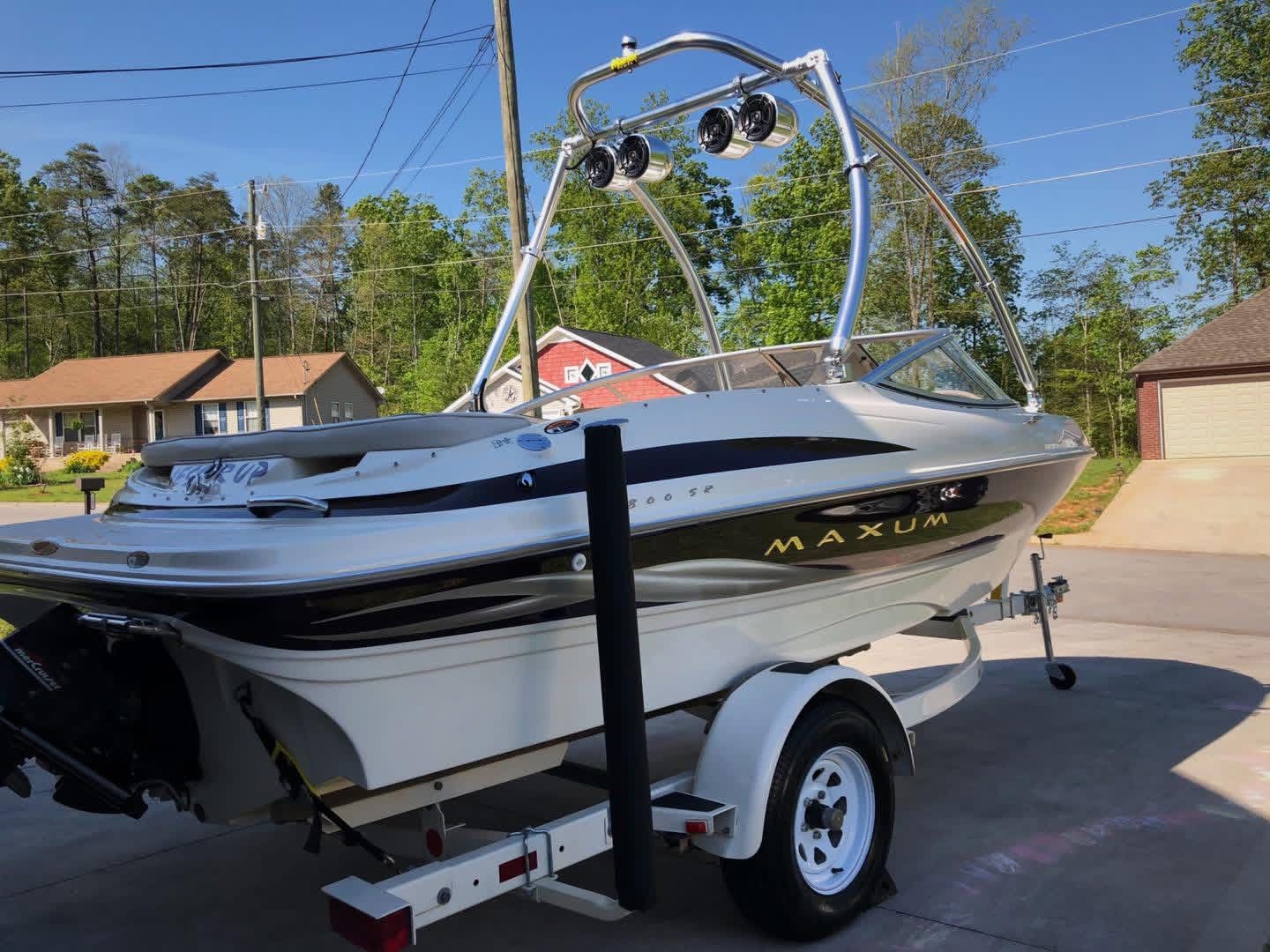 1999 Maxum 1800 SR boat parked on trailer outdoors.