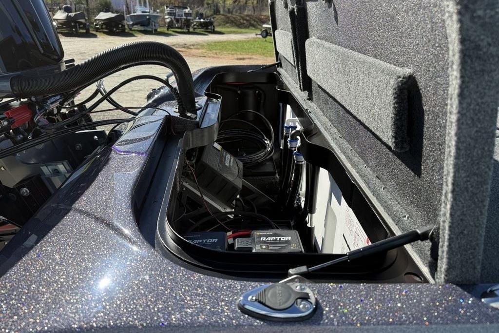 Open storage compartment of 2026 Skeeter ZXE21 boat, showing internal components and wiring.